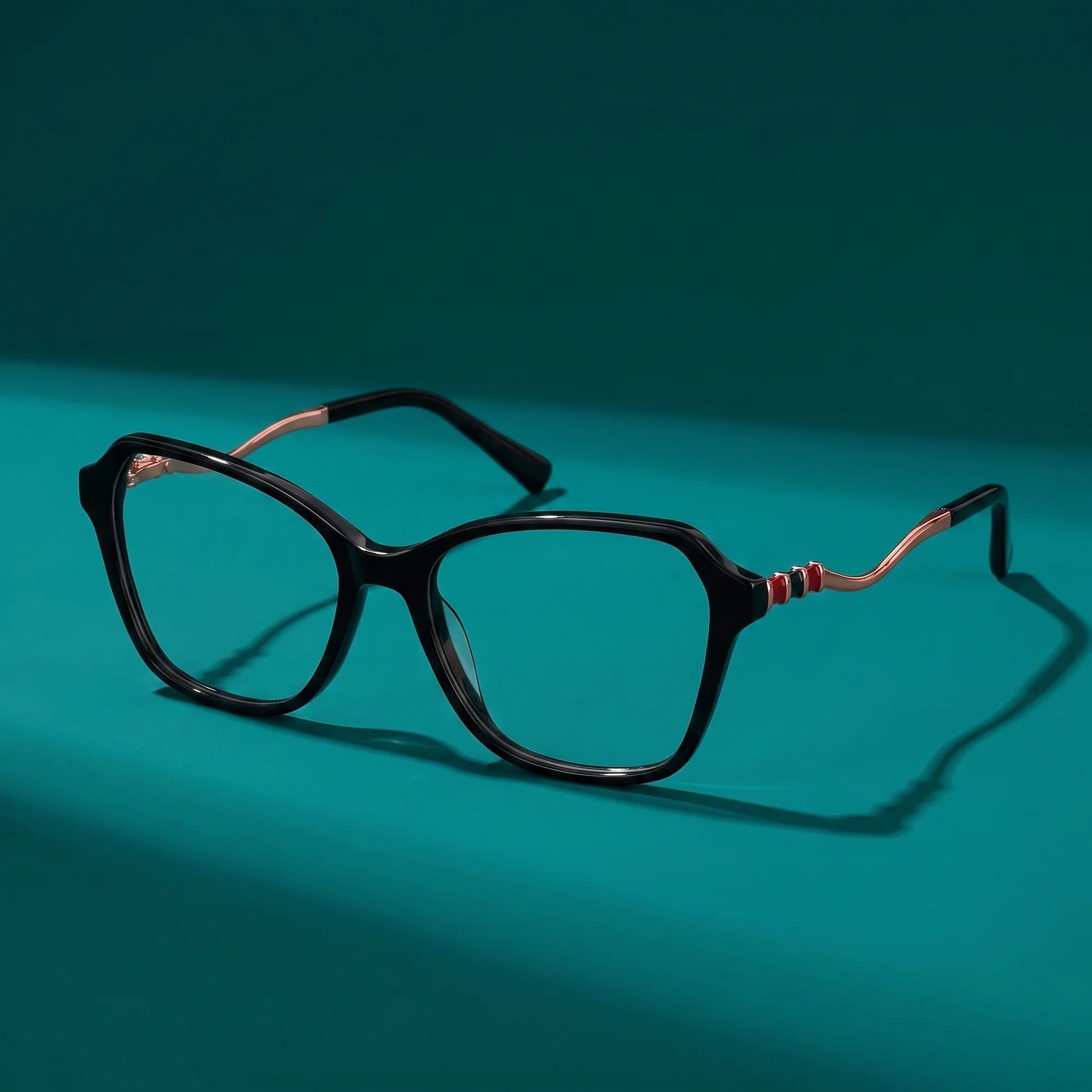 Fiore 1030 eyeglasses in black – still life on a seamless teal studio backdrop
