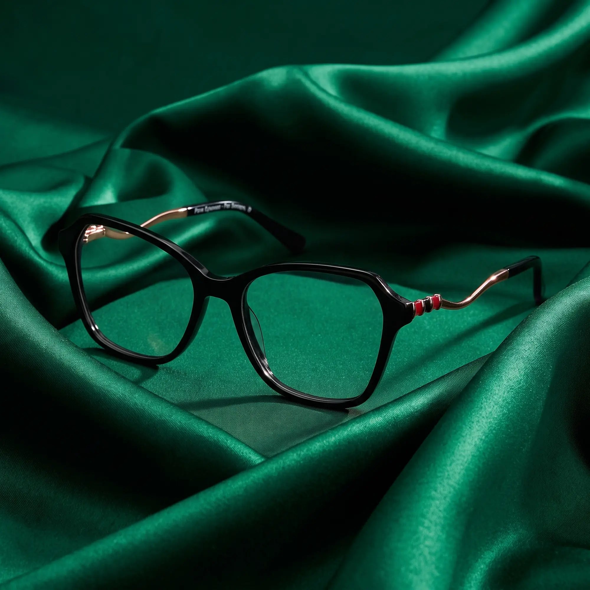 Fiore 1030 eyeglasses in black – nested in flowing emerald silk