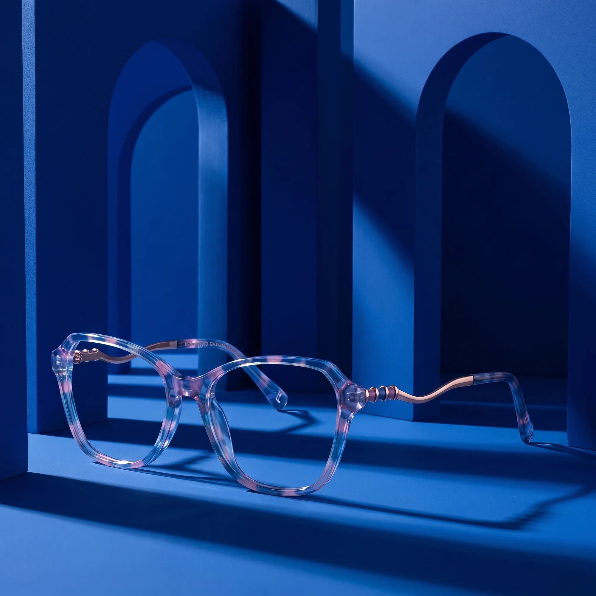 Fiore 1030 eyeglasses in blue pink – still life among monochrome cobalt arches