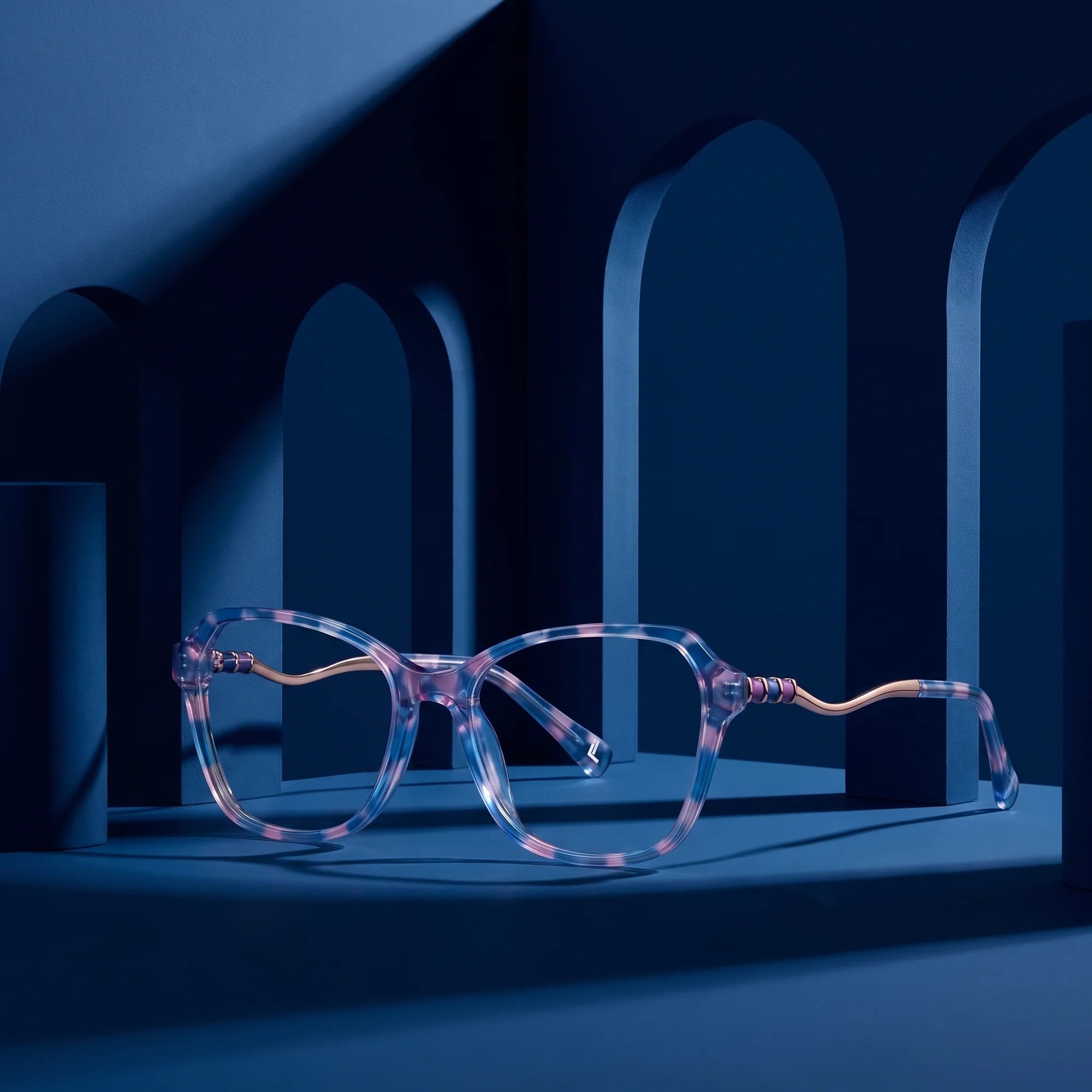 Fiore 1030 eyeglasses in blue pink – staged on a sculptural midnight blue architecture set