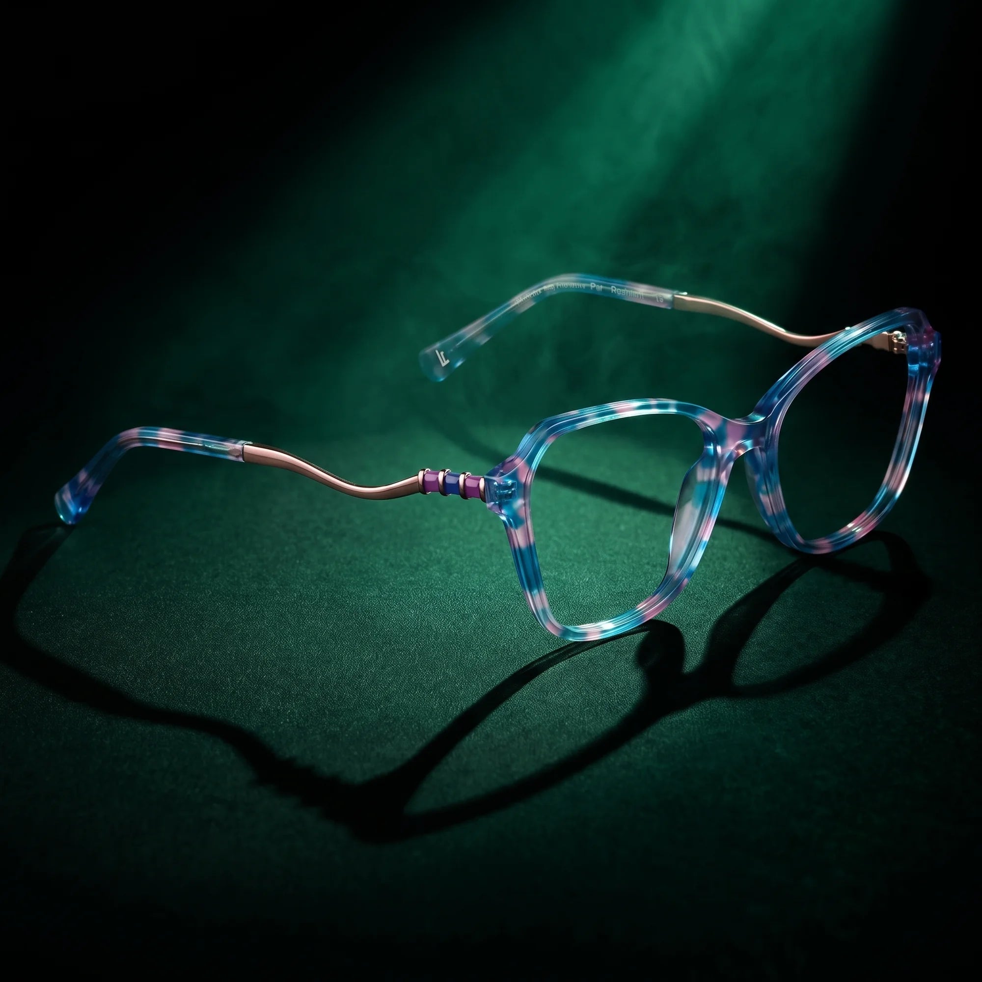Fiore 1030 eyeglasses in blue pink – under a theatrical beam of light