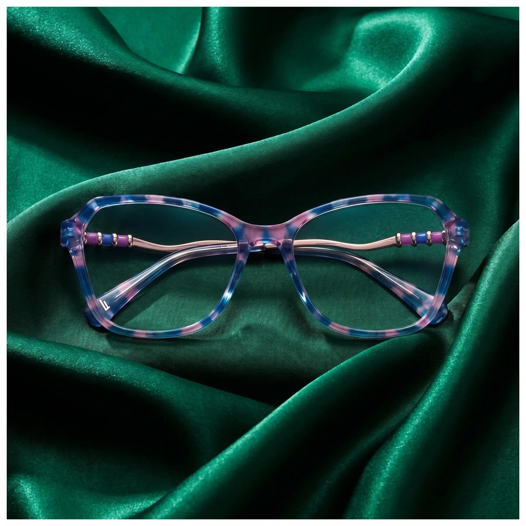Fiore 1030 eyeglasses in blue pink – nested in flowing emerald silk