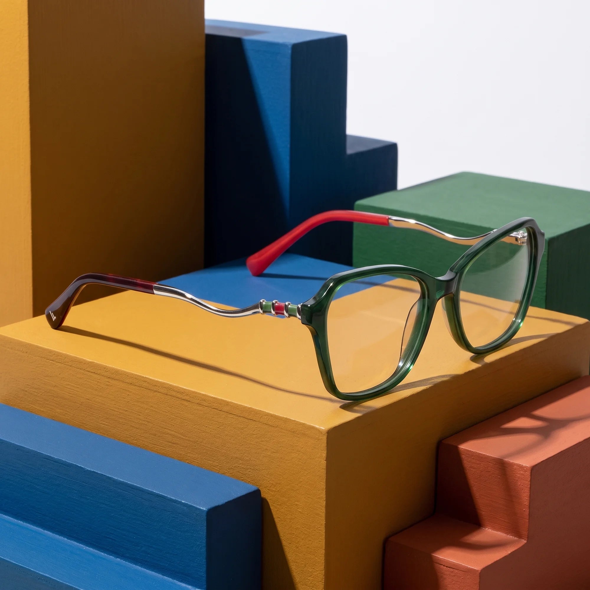 Fiore 1030 eyeglasses in green – on bold primary color-block steps