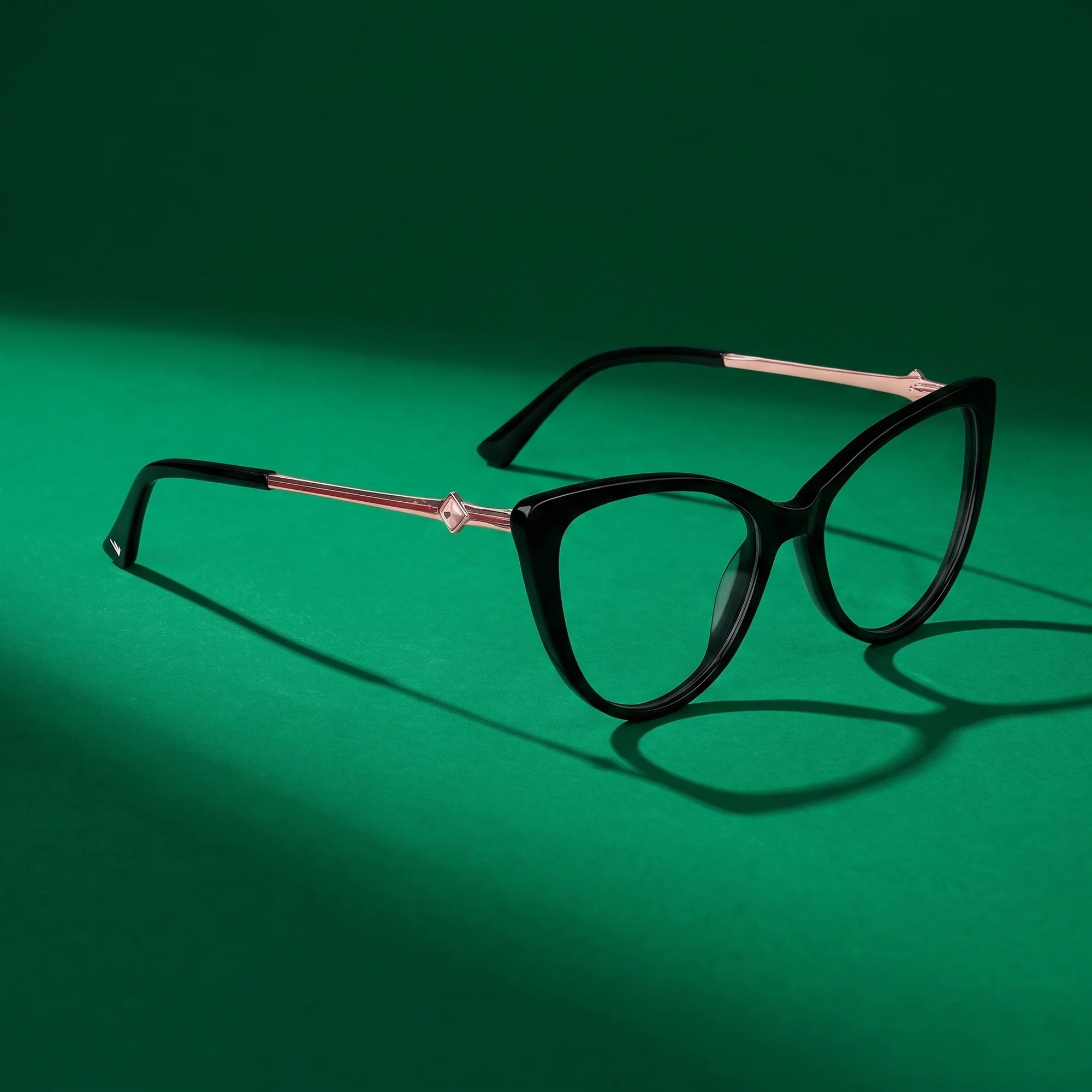 Fiore 1031 eyeglasses in black – editorial still life on a saturated emerald set