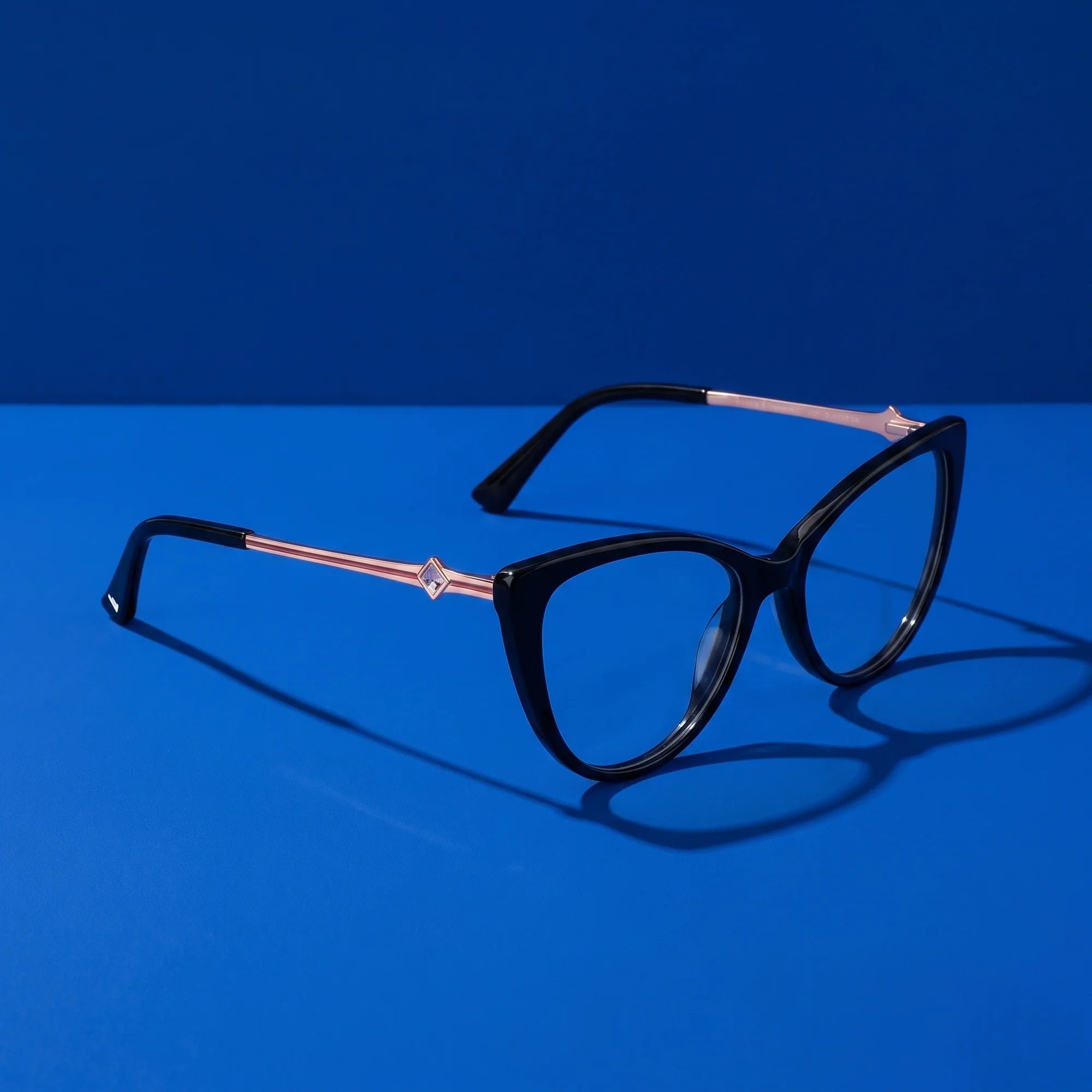 Fiore 1031 eyeglasses in black – still life on a seamless cobalt studio backdrop