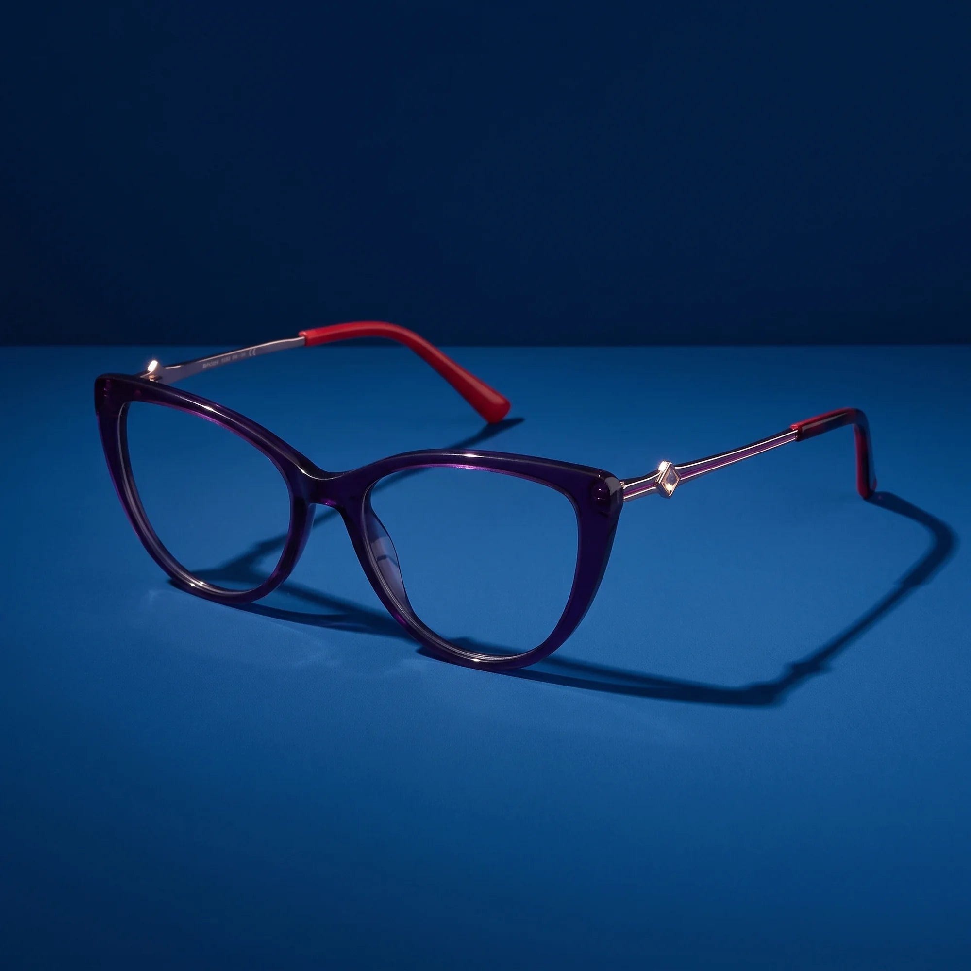 Fiore 1031 eyeglasses in purple green – still life on a seamless midnight blue studio backdrop