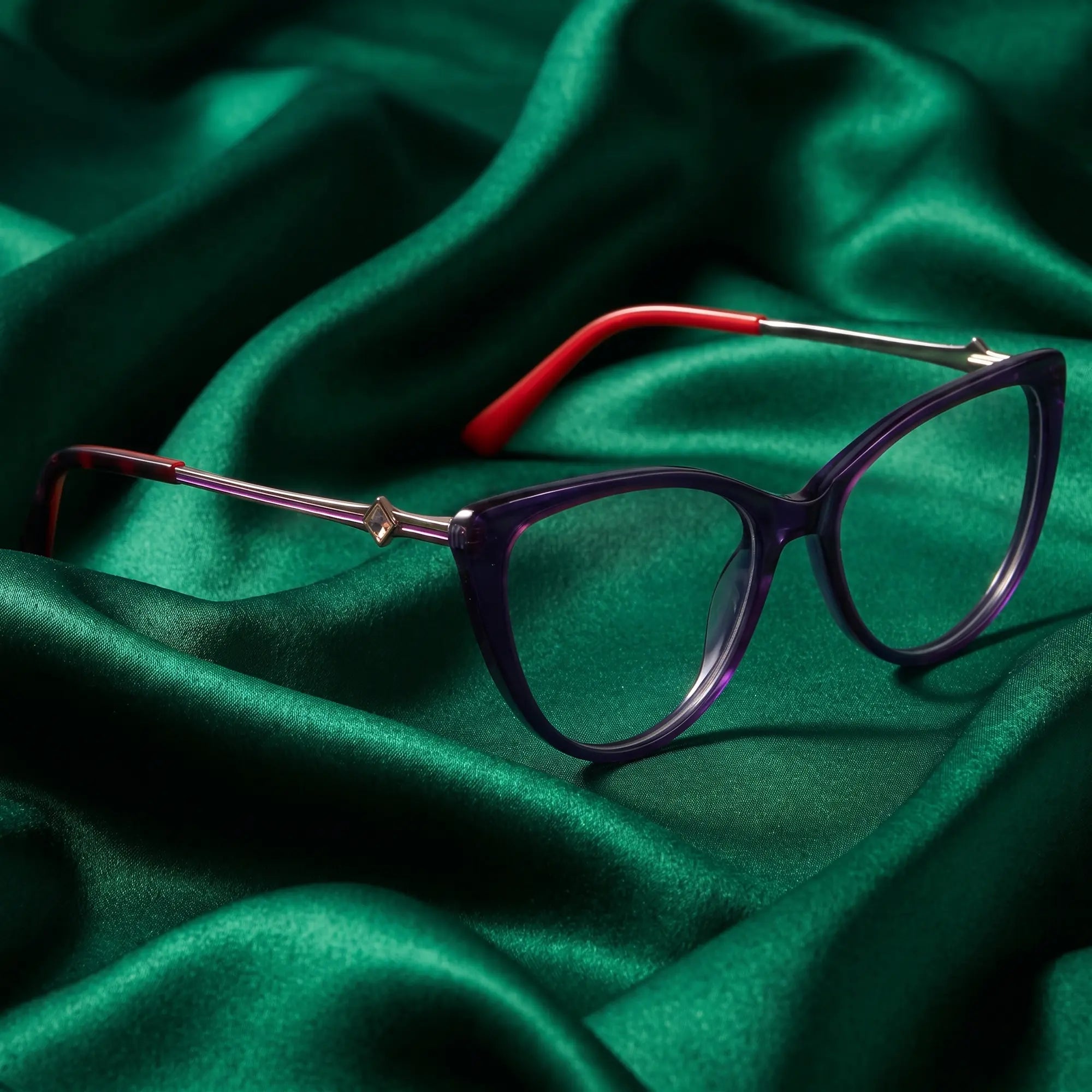Fiore 1031 eyeglasses in purple green – nested in flowing emerald silk