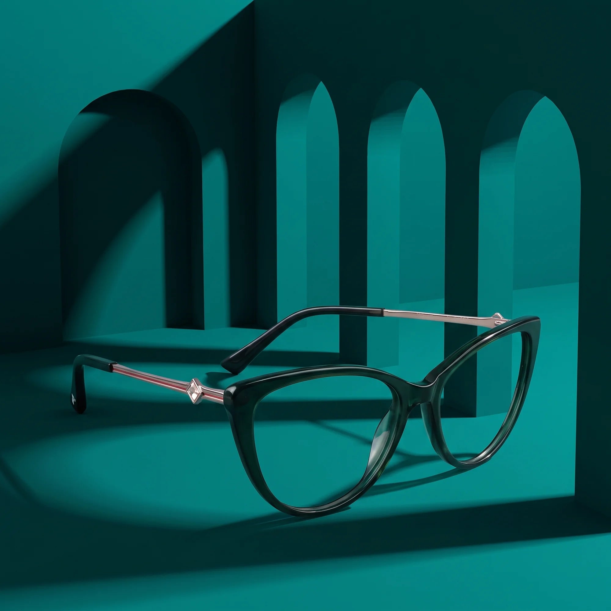 Fiore 1031 eyeglasses in green – staged on a sculptural teal architecture set