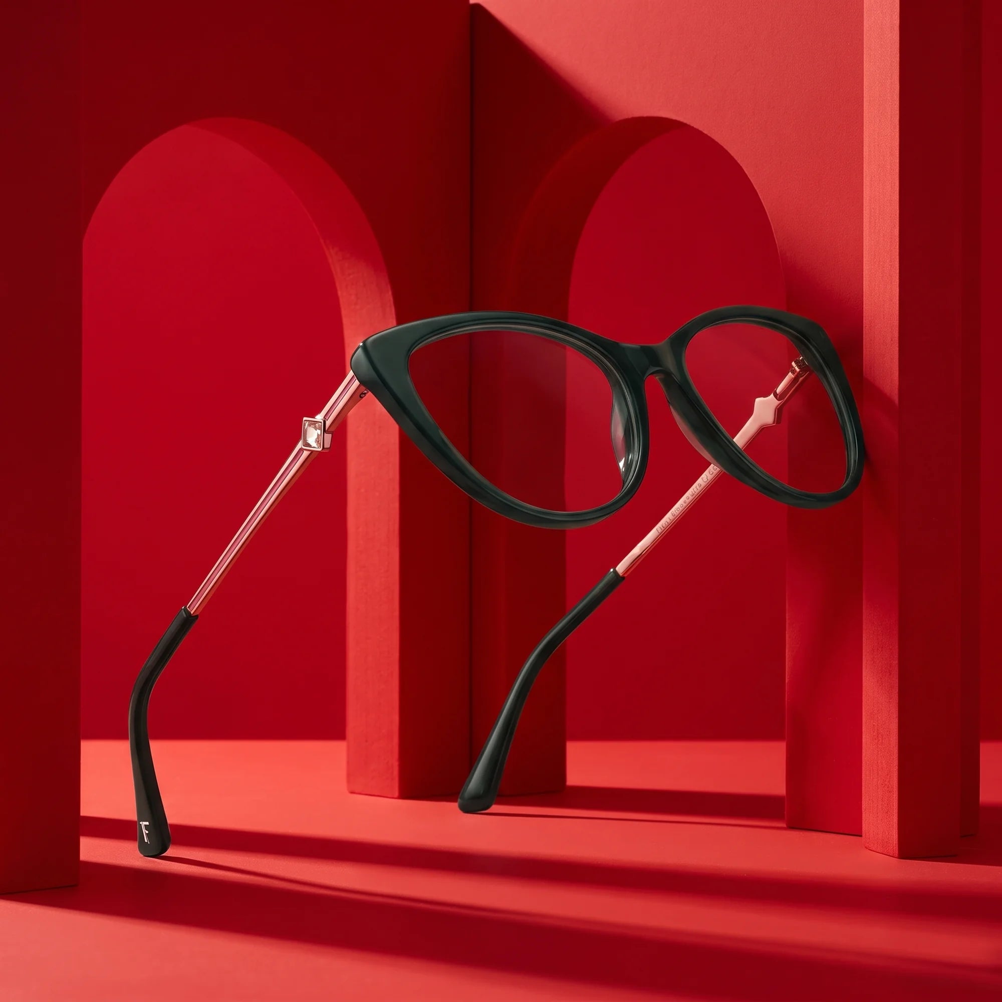 Fiore 1031 eyeglasses in green – displayed on a vivid red podium among arches