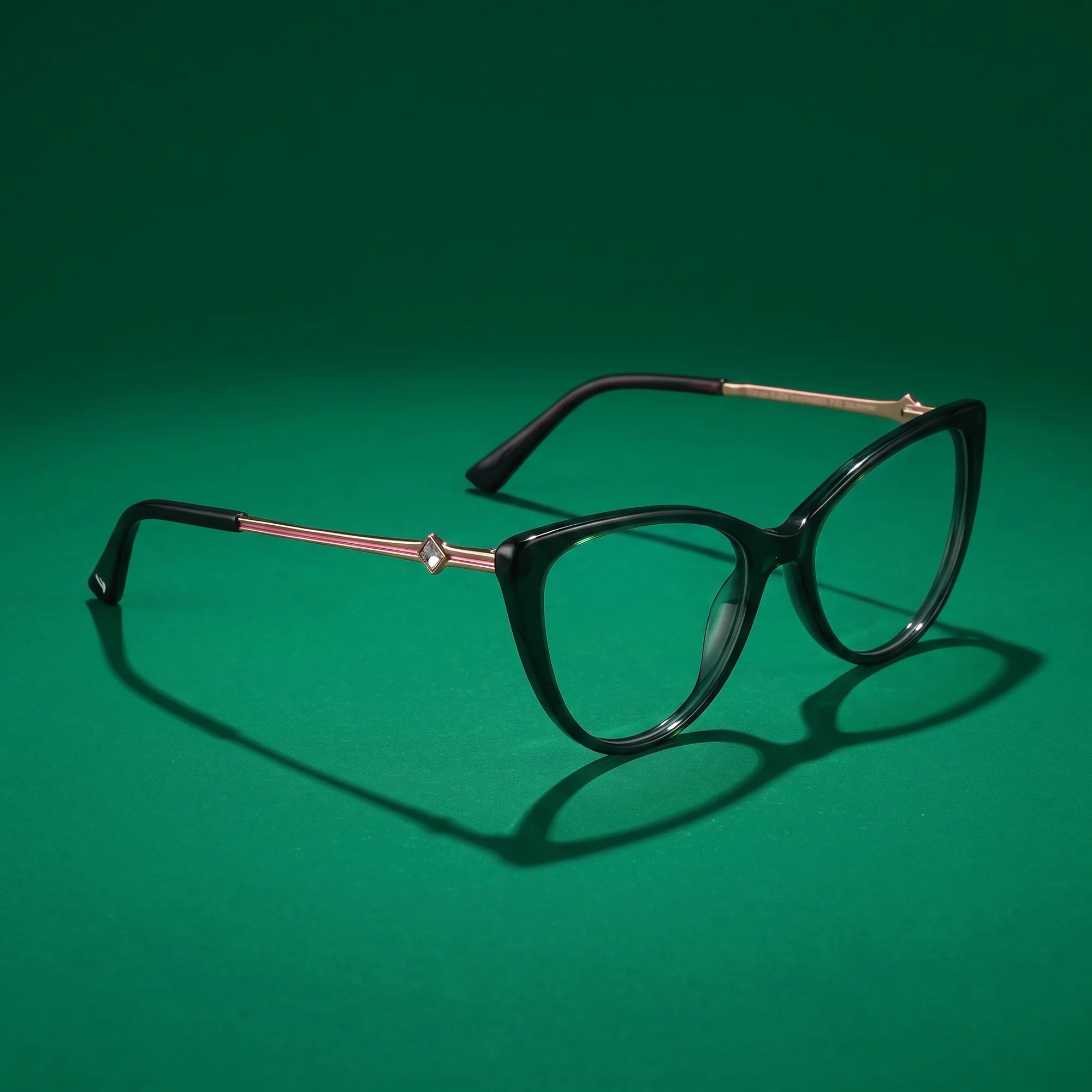 Fiore 1031 eyeglasses in green – hero still life against a deep emerald backdrop