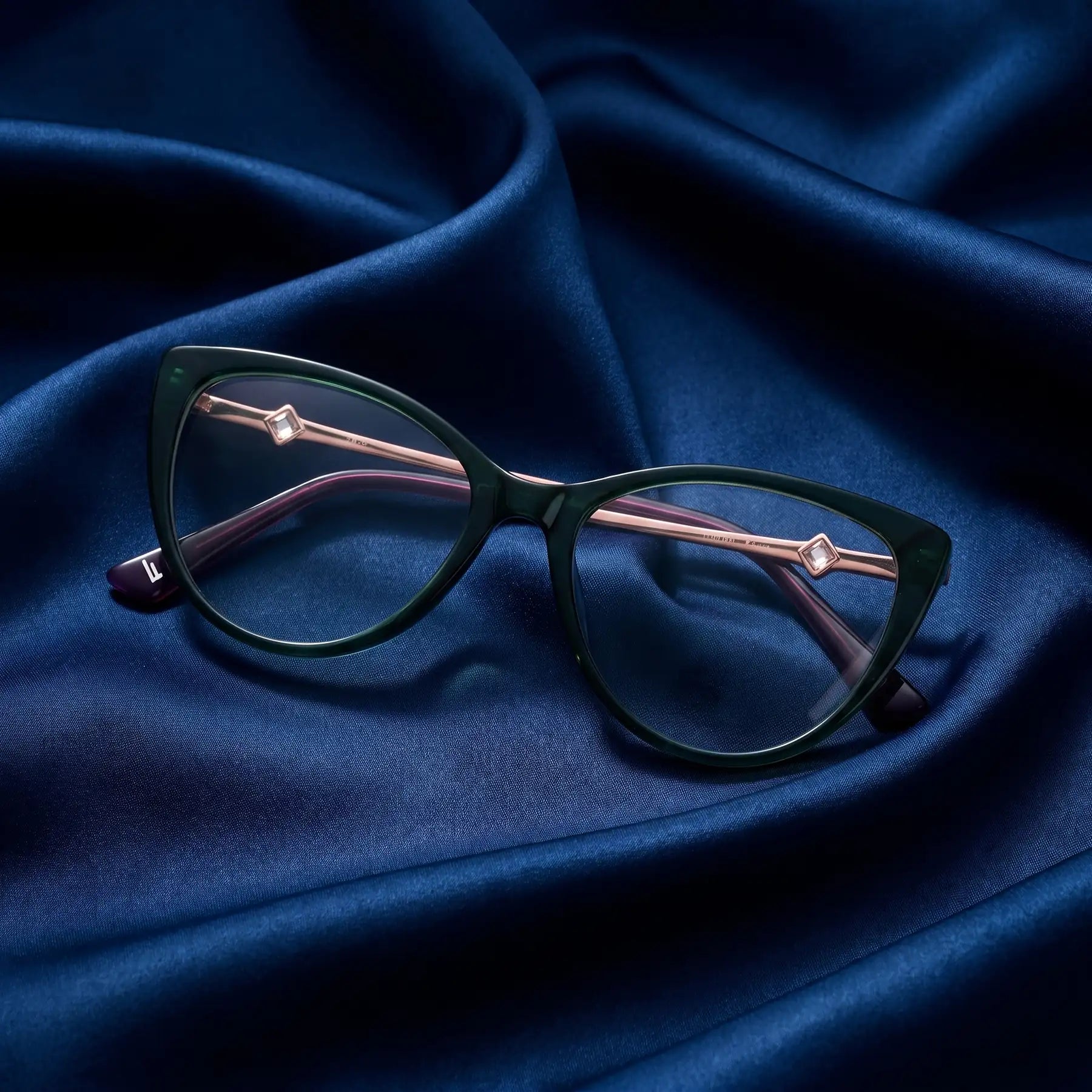 Fiore 1031 eyeglasses in green – nested in flowing midnight blue silk