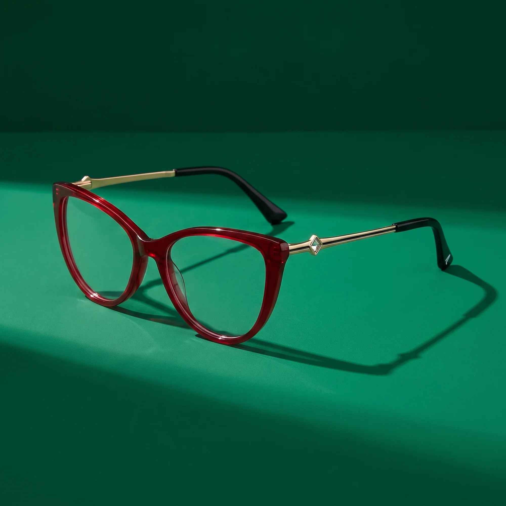 Fiore 1031 eyeglasses in red – editorial still life on a saturated emerald set