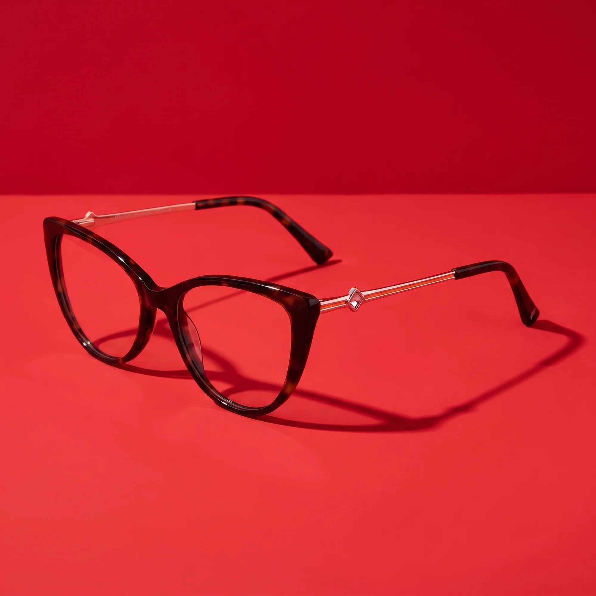 Fiore 1031 eyeglasses in tortoiseshell – editorial still life on a saturated vivid red set
