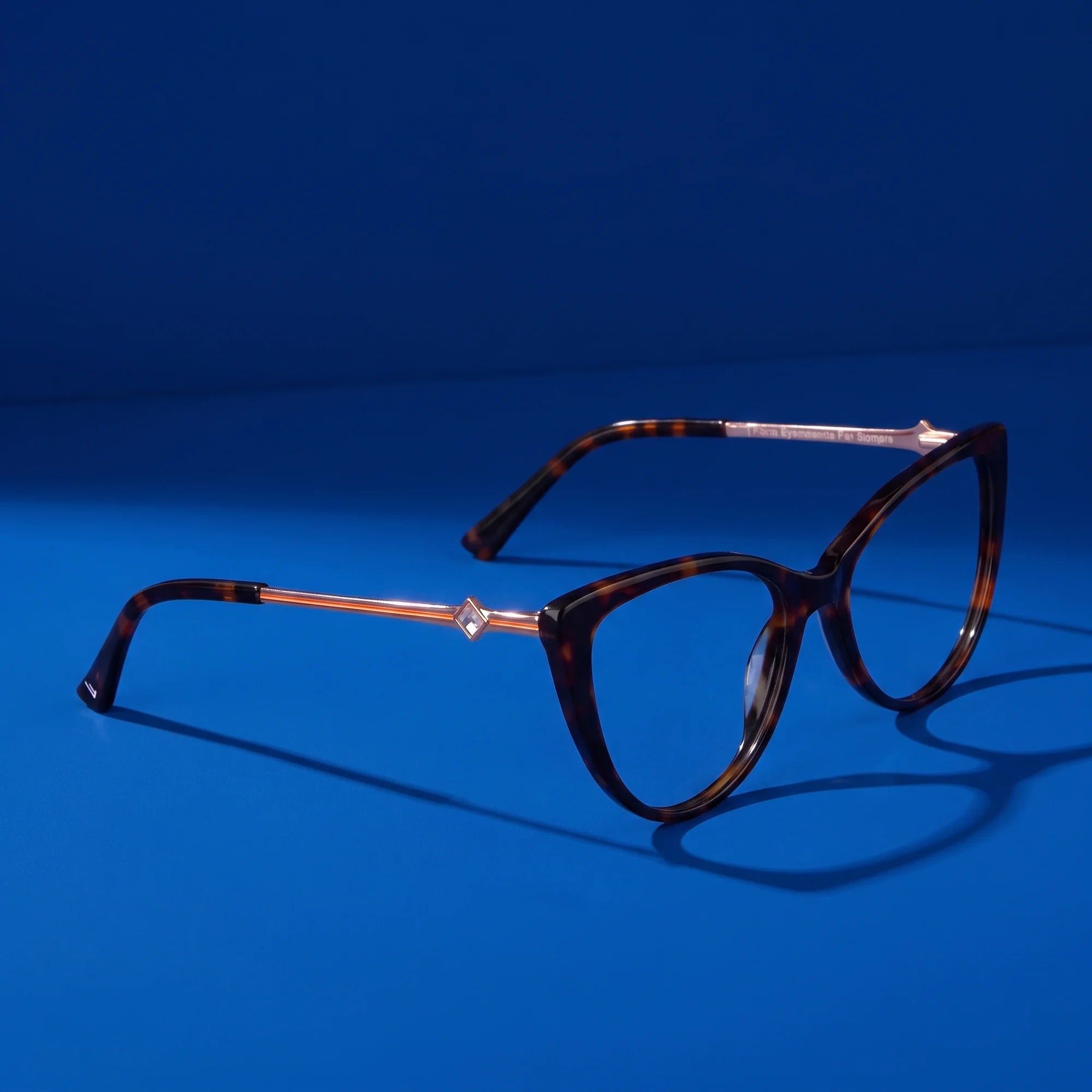Fiore 1031 eyeglasses in tortoiseshell – hero still life against a deep cobalt backdrop