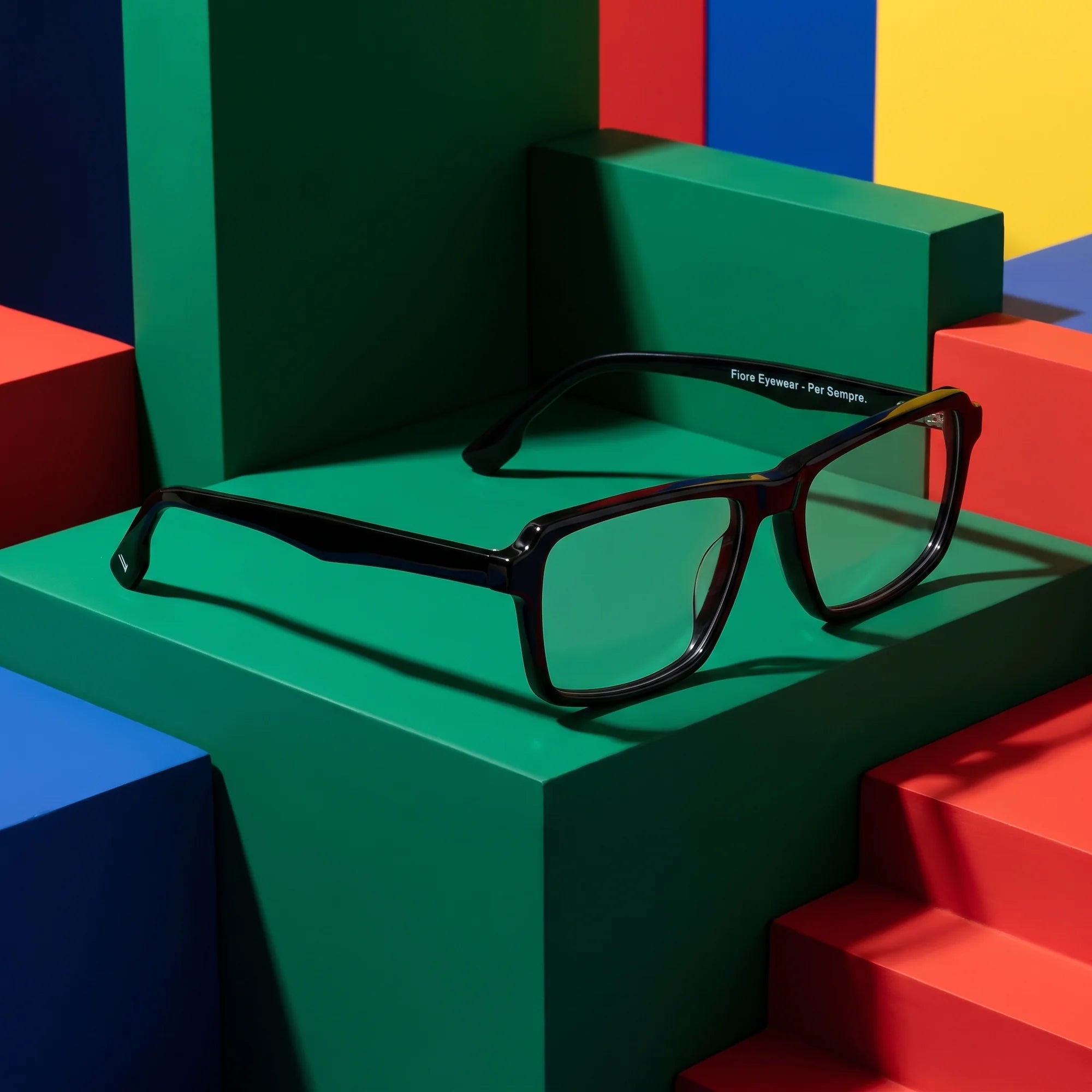 Fiore 1038 eyeglasses in black – on bold primary color-block steps