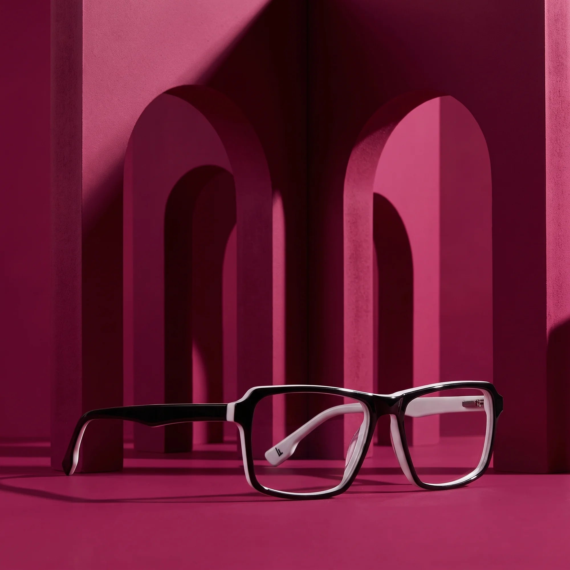 Fiore 1038 eyeglasses in black white – staged on a sculptural magenta architecture set