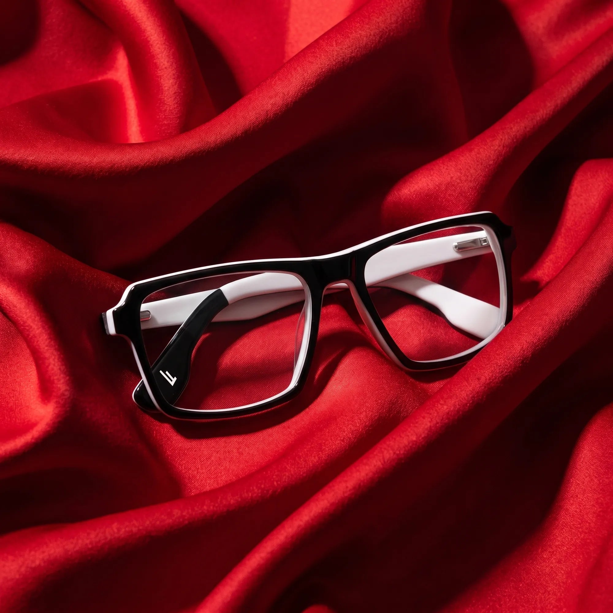 Fiore 1038 eyeglasses in black white – nested in flowing vivid red silk