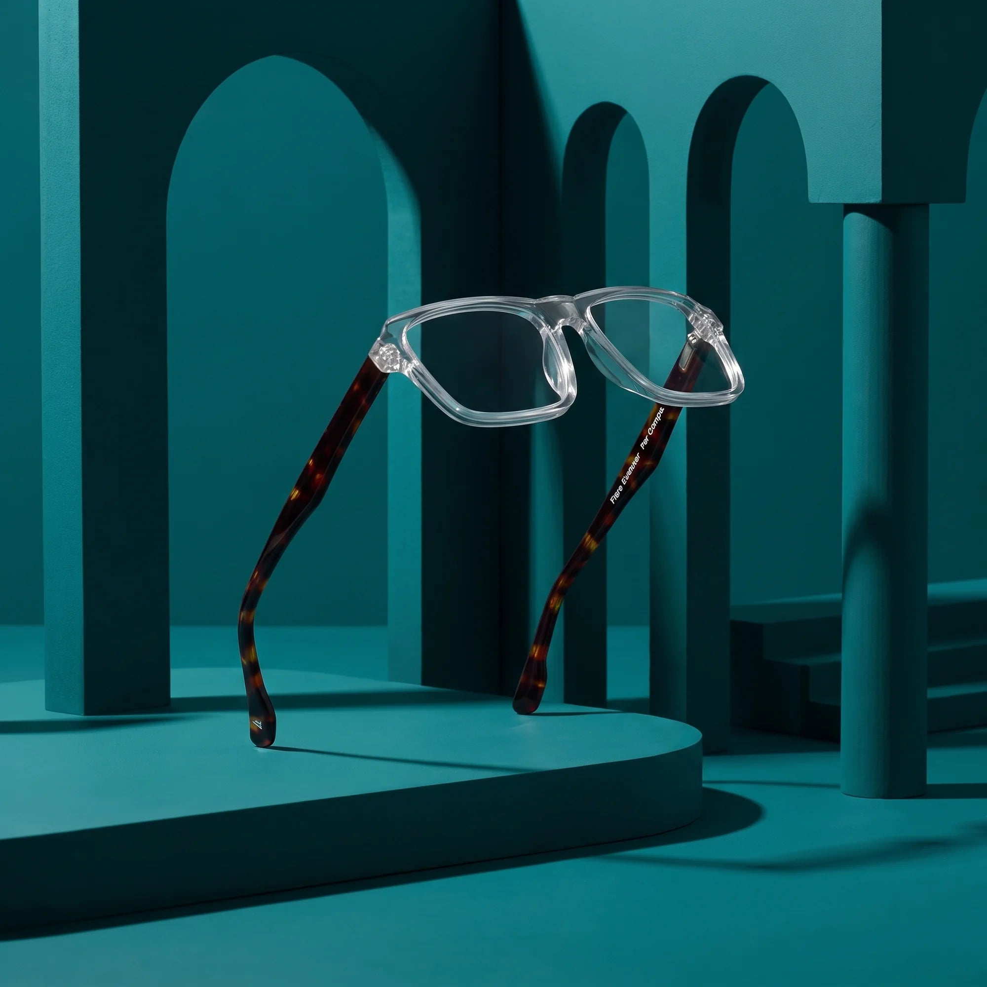 Fiore 1038 eyeglasses in transparent – still life among monochrome teal arches