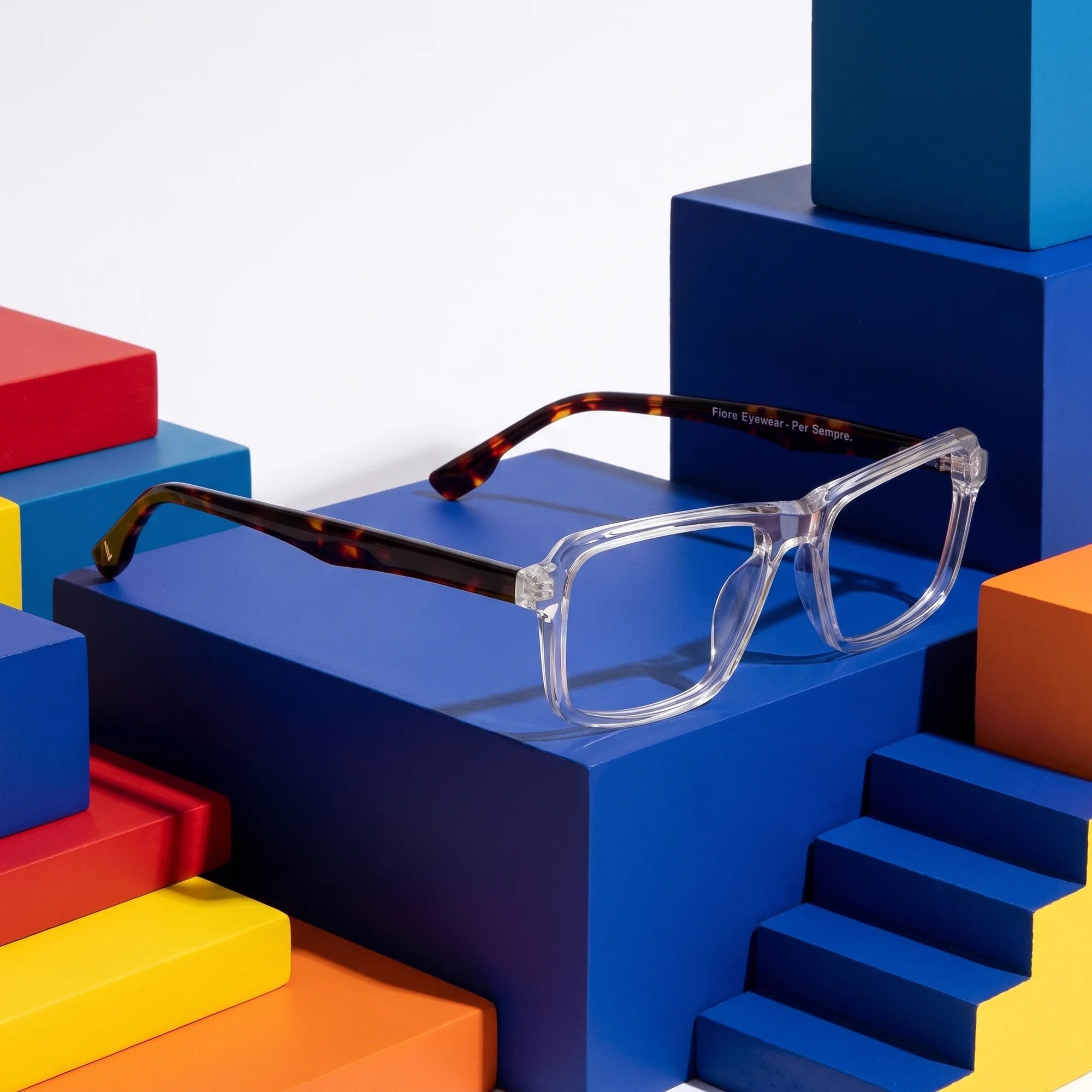 Fiore 1038 eyeglasses in transparent – on bold primary color-block steps