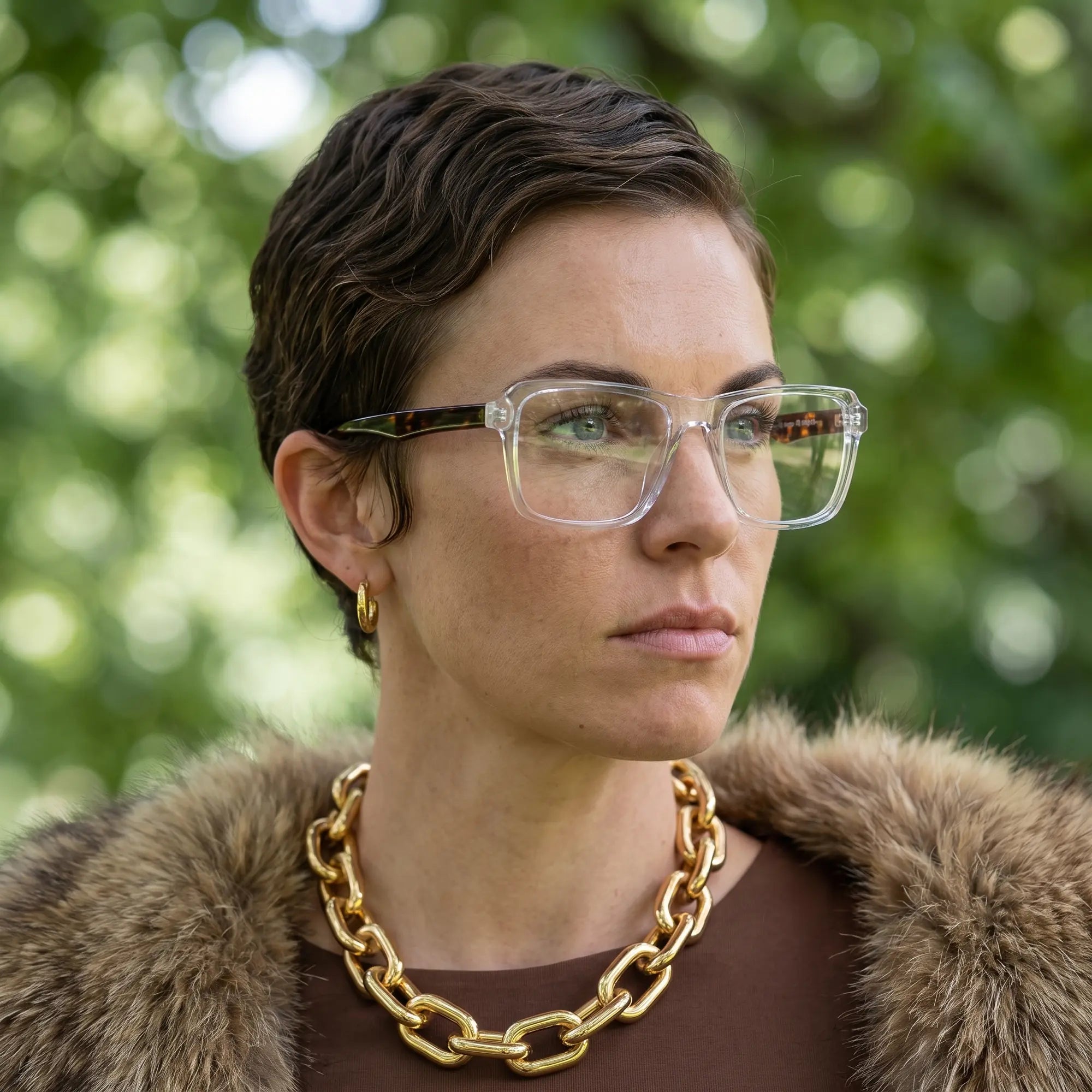 Fiore 1038 eyeglasses in transparent, worn by a model – campaign portrait, fur-collar portrait in dappled daylight