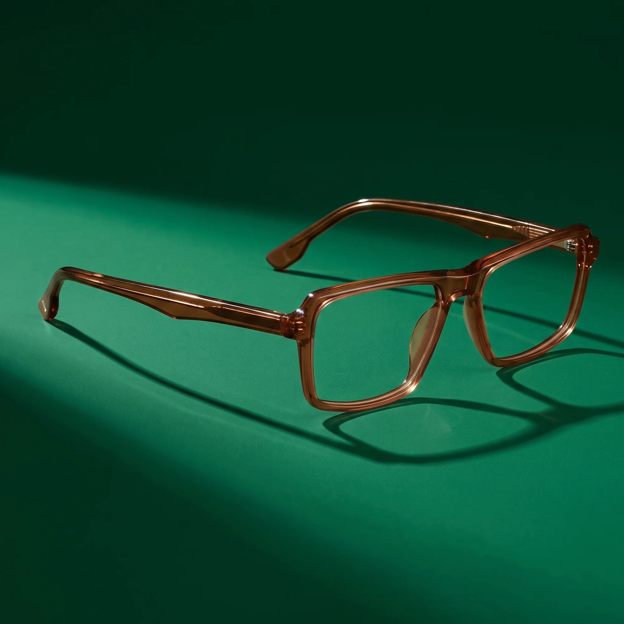 Fiore 1038 eyeglasses in brown – still life on a seamless emerald studio backdrop