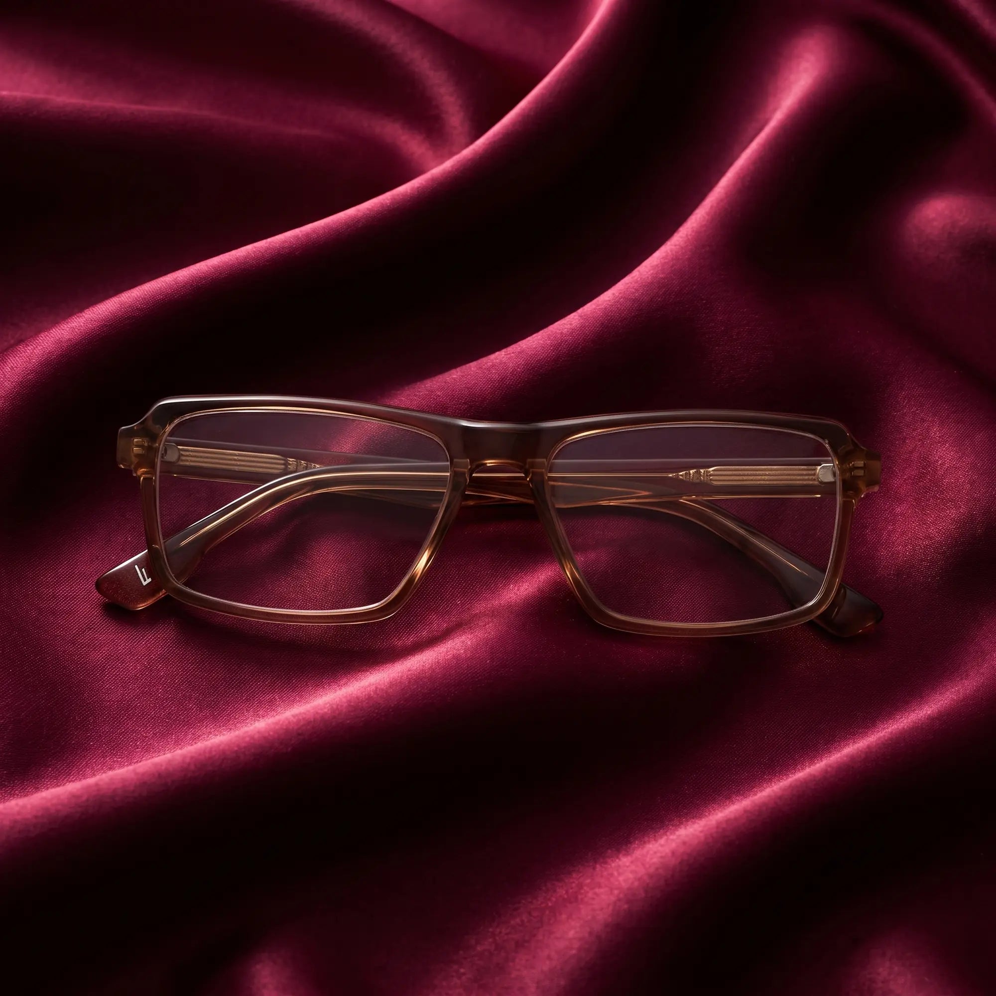 Fiore 1038 eyeglasses in brown – nested in flowing burgundy silk