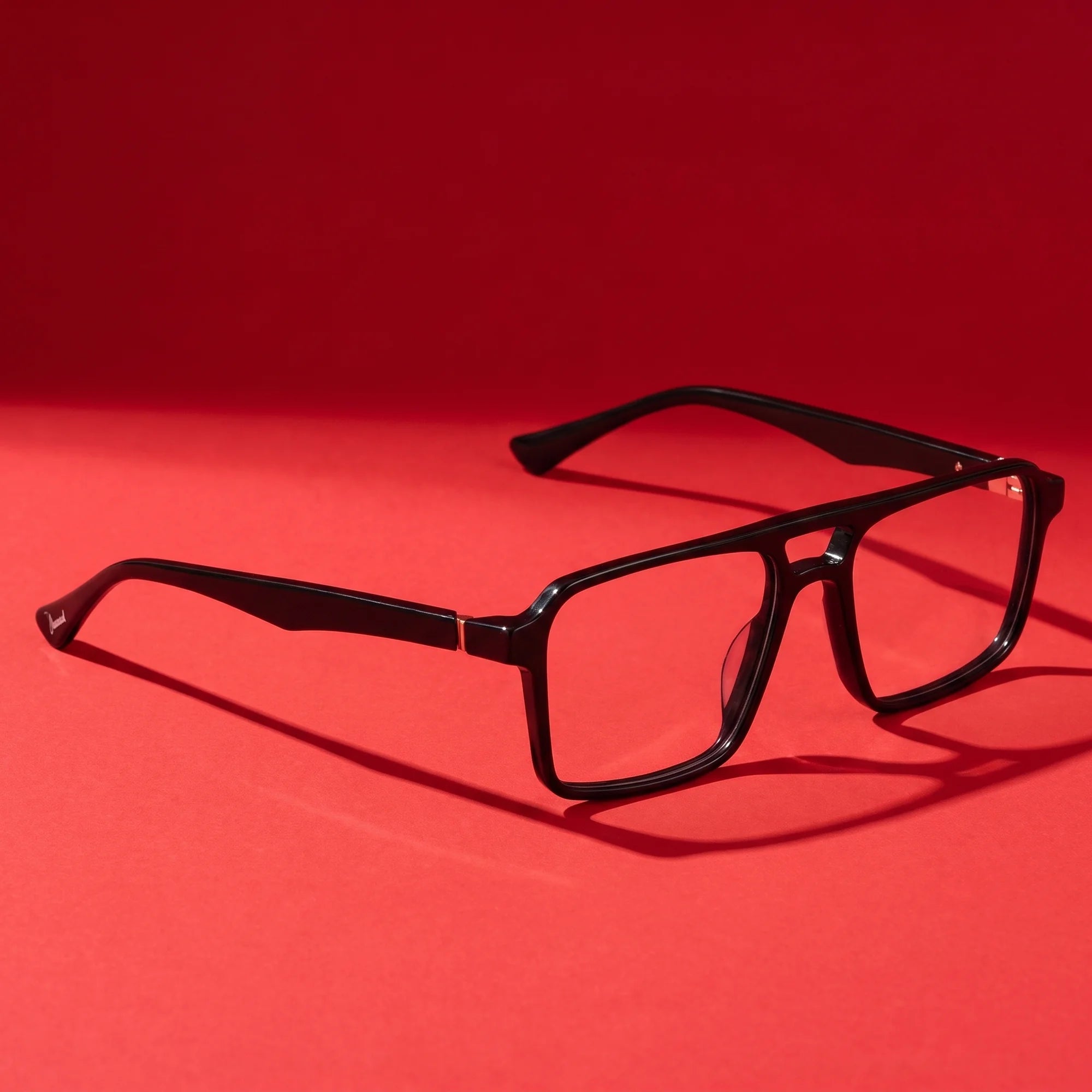 Fiore 1039 eyeglasses in black – editorial still life on a saturated vivid red set