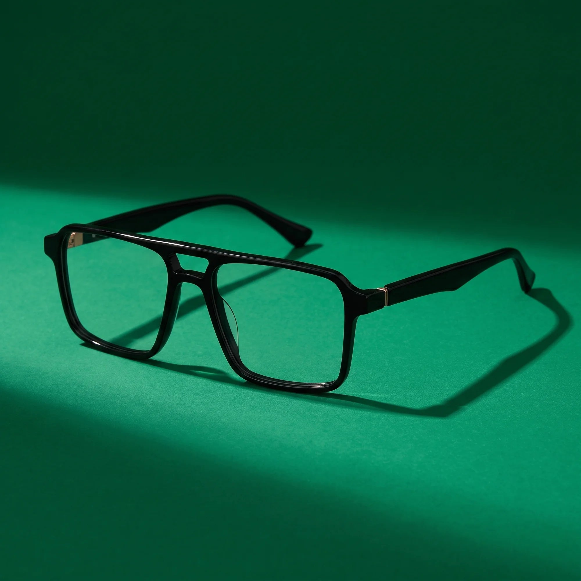 Fiore 1039 eyeglasses in black – still life on a seamless emerald studio backdrop