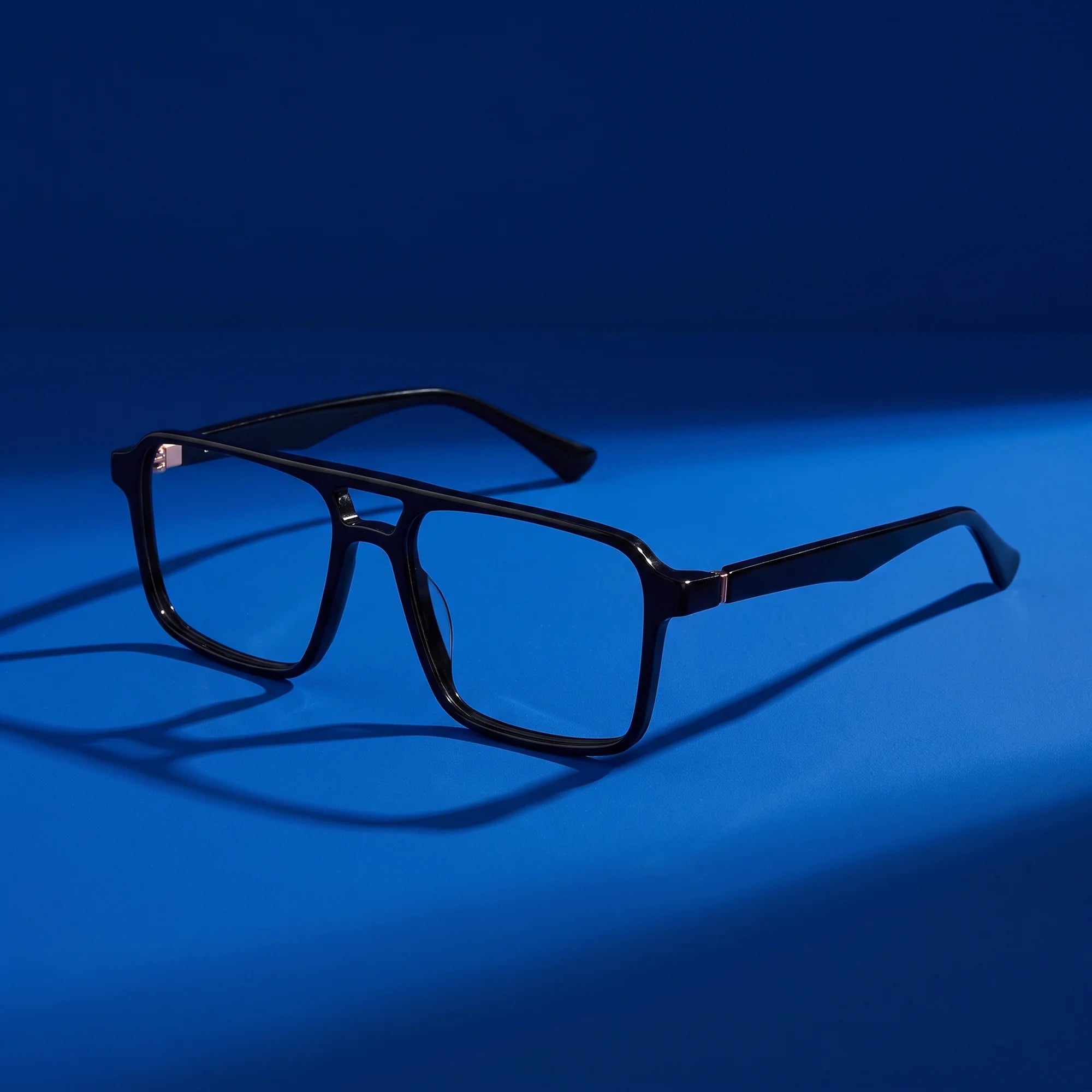 Fiore 1039 eyeglasses in black – hero still life against a deep cobalt backdrop