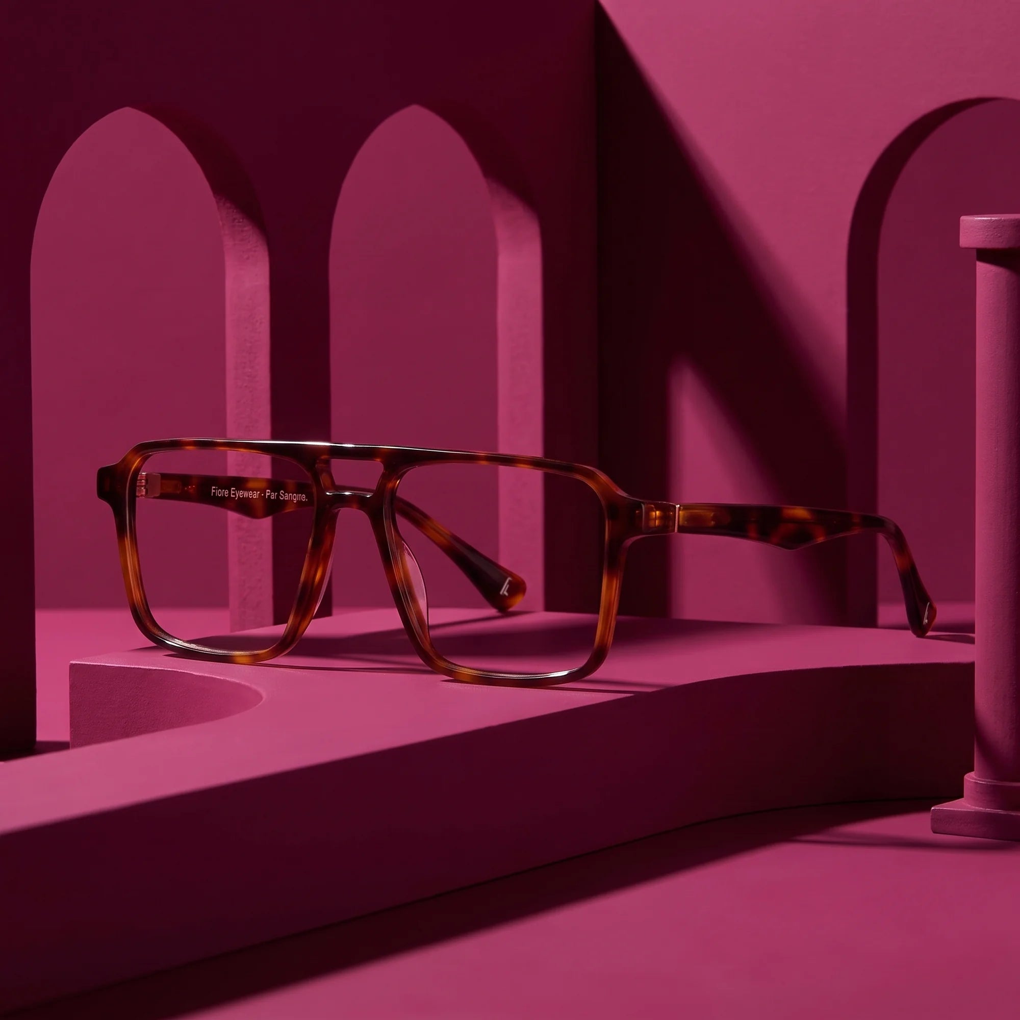 Fiore 1039 eyeglasses in tortoiseshell – staged on a sculptural magenta architecture set