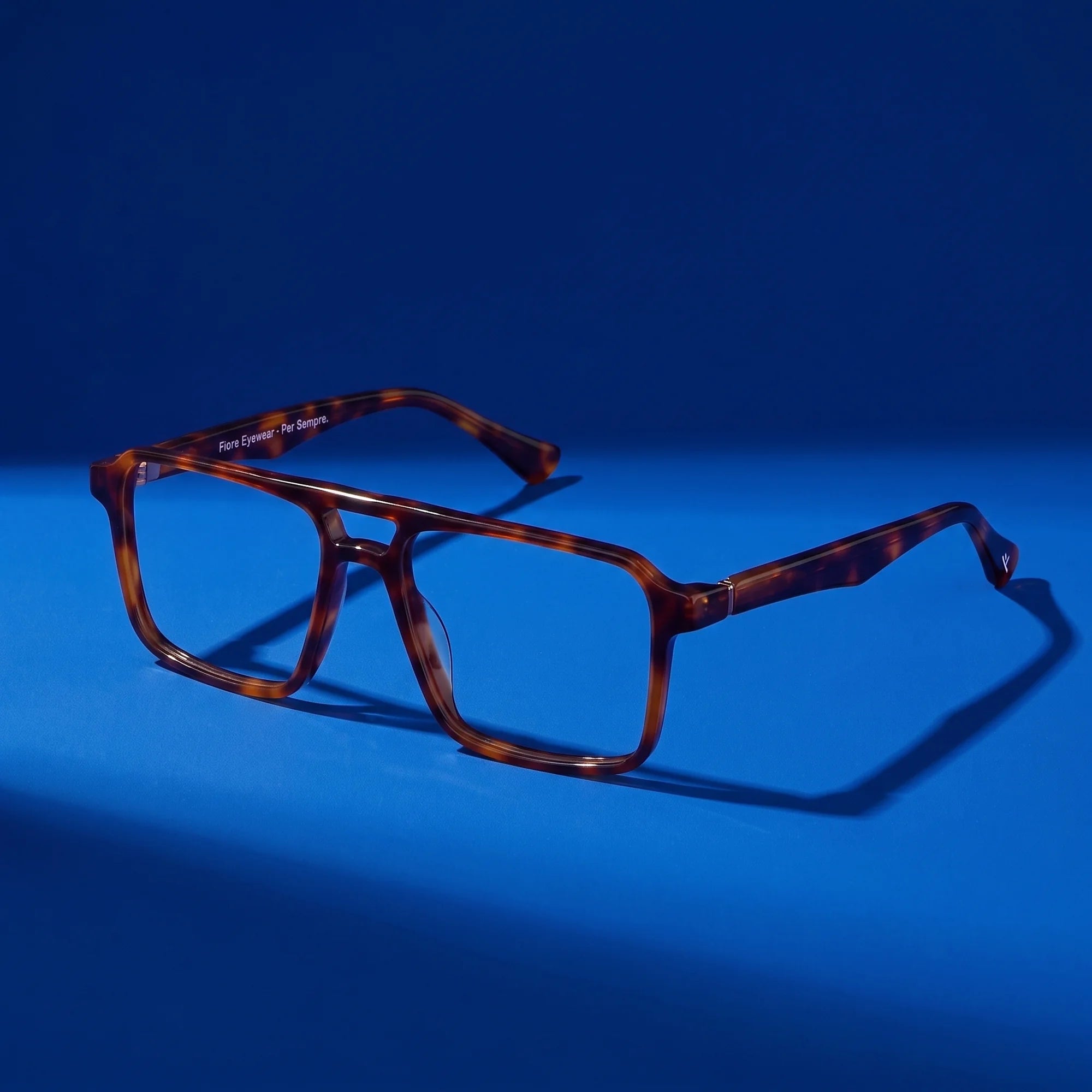 Fiore 1039 eyeglasses in tortoiseshell – still life on a seamless cobalt studio backdrop