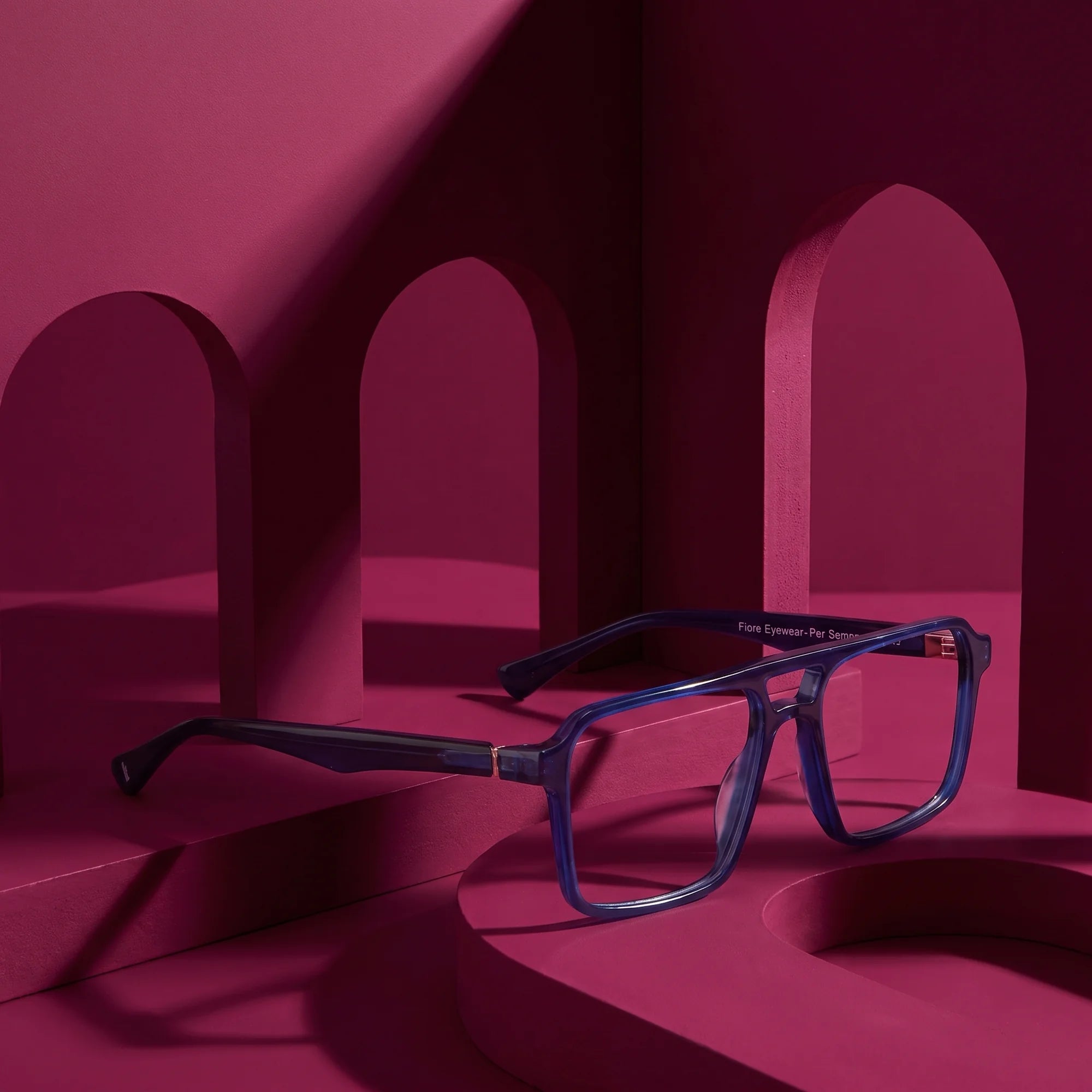 Fiore 1039 eyeglasses in blue – still life among monochrome magenta arches