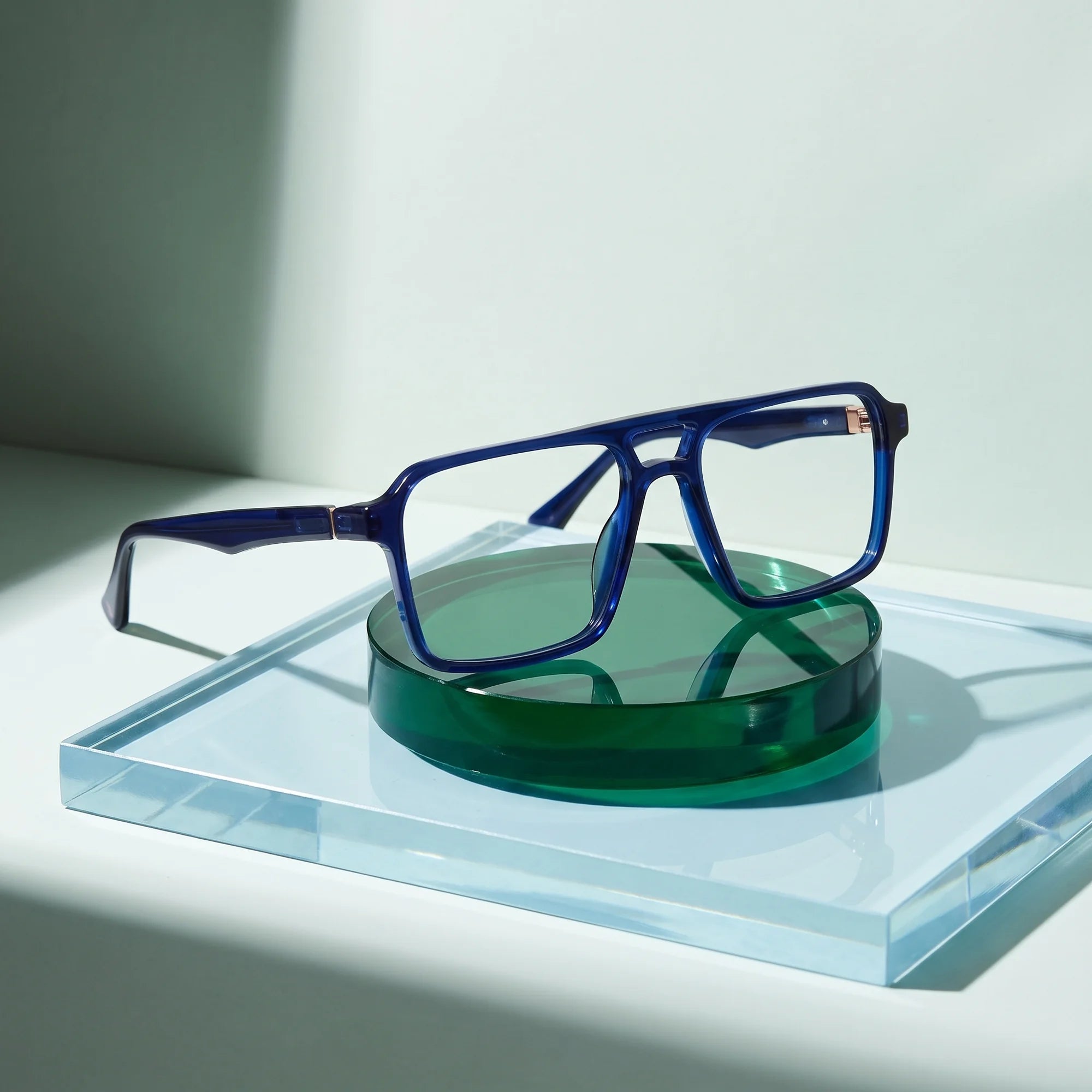 Fiore 1039 eyeglasses in blue – on a cobalt acrylic disc in soft daylight