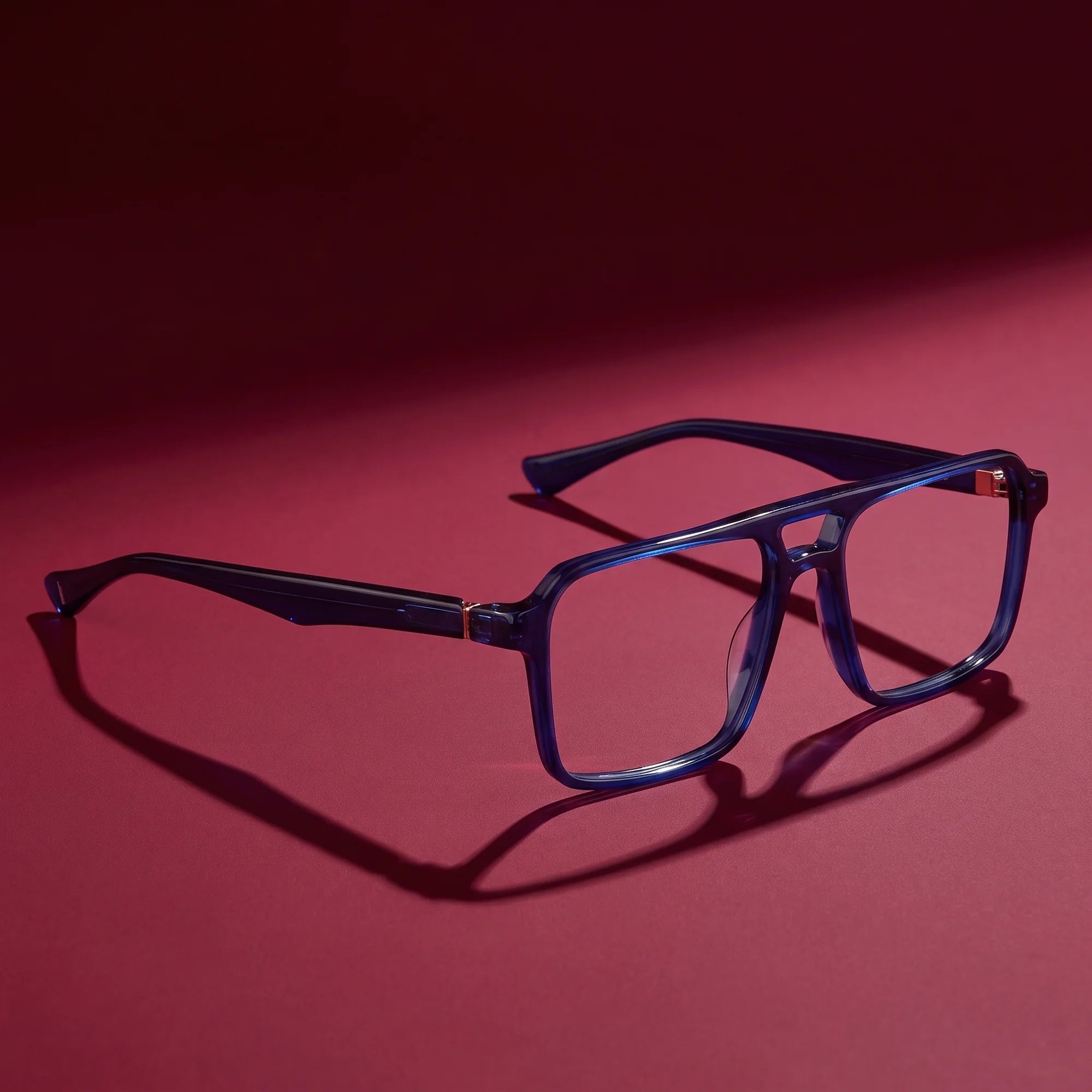 Fiore 1039 eyeglasses in blue – editorial still life on a saturated burgundy set