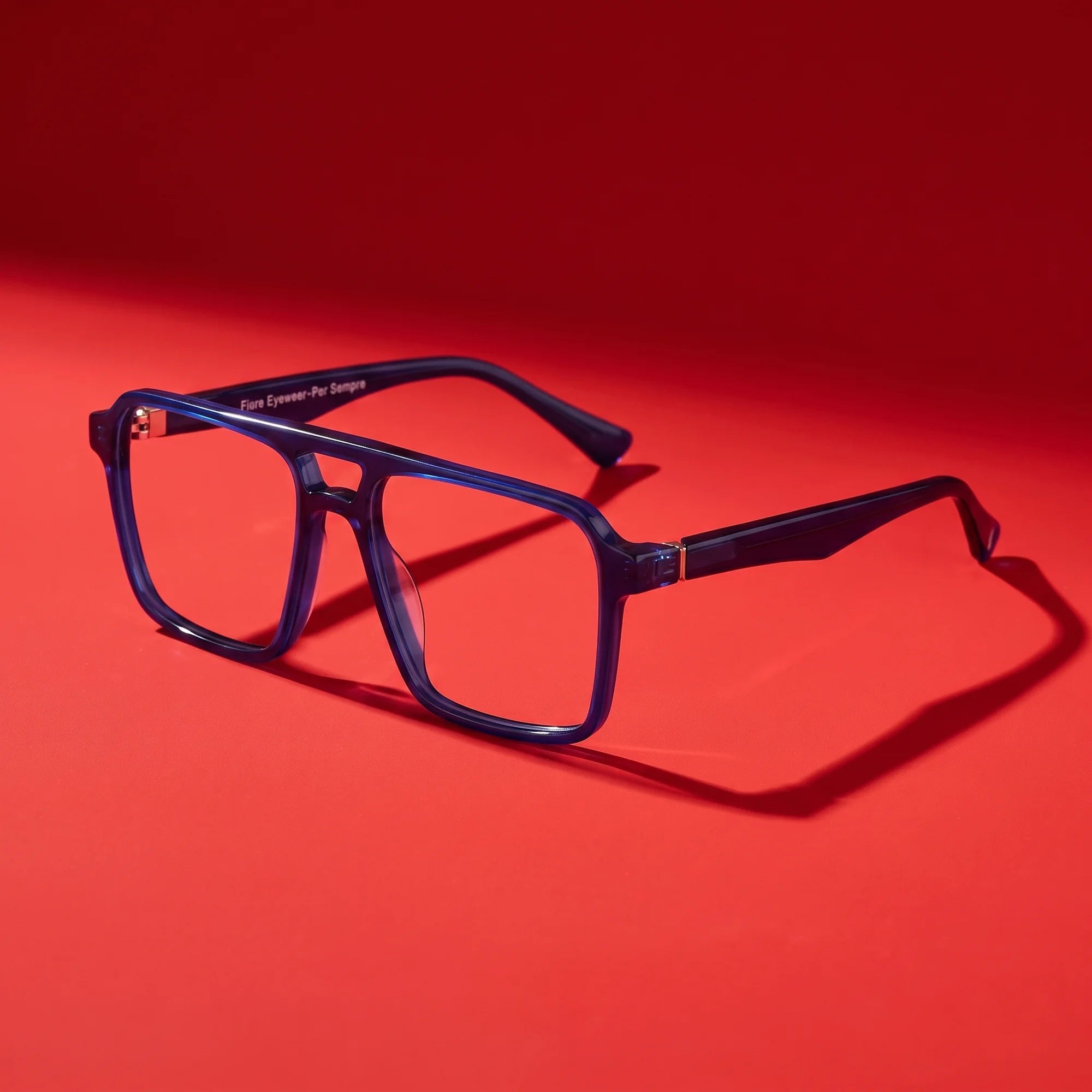 Fiore 1039 eyeglasses in blue – hero still life against a deep vivid red backdrop