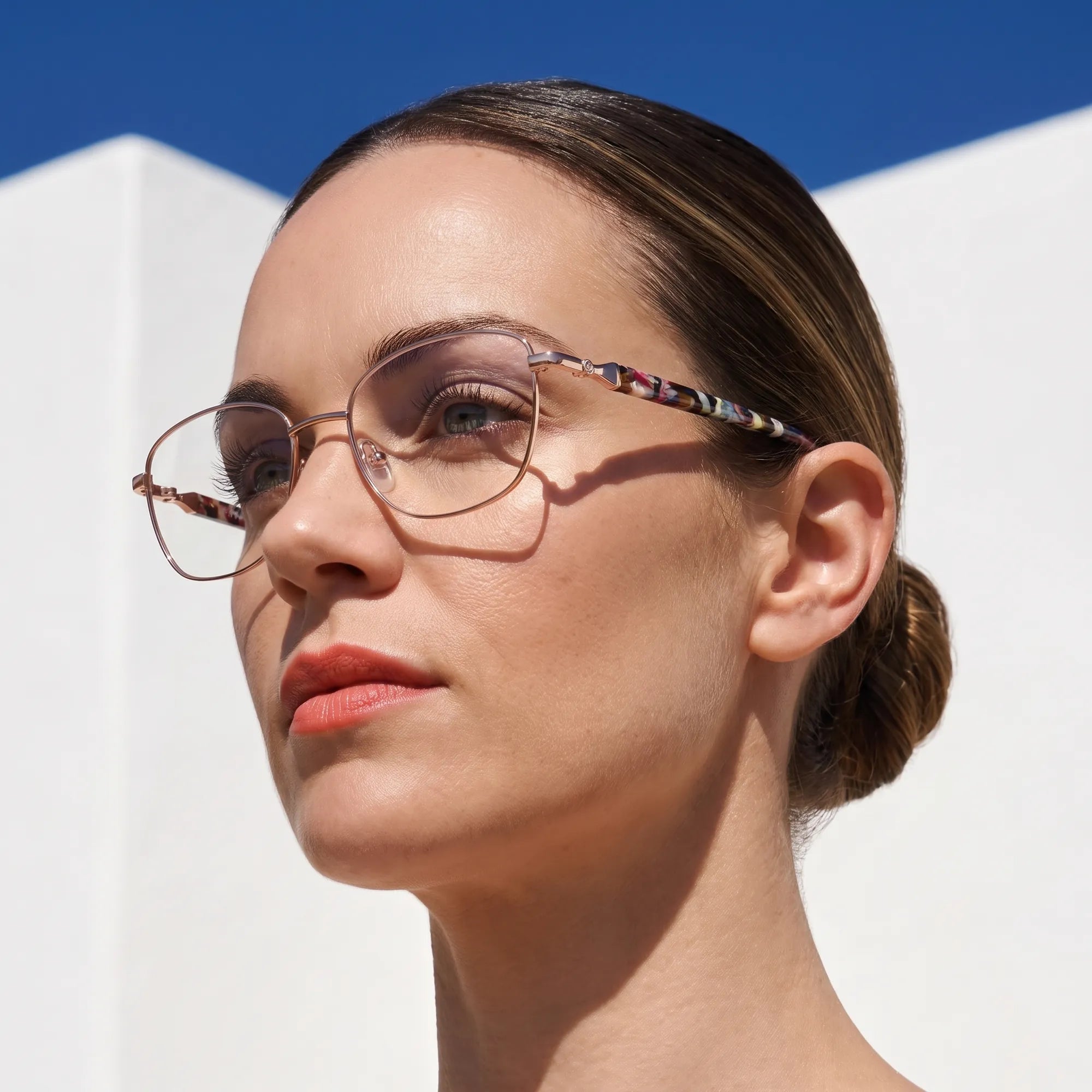 Fiore 2208 eyeglasses in brown gold, worn by a model – campaign portrait, island rooftop portrait in summer light
