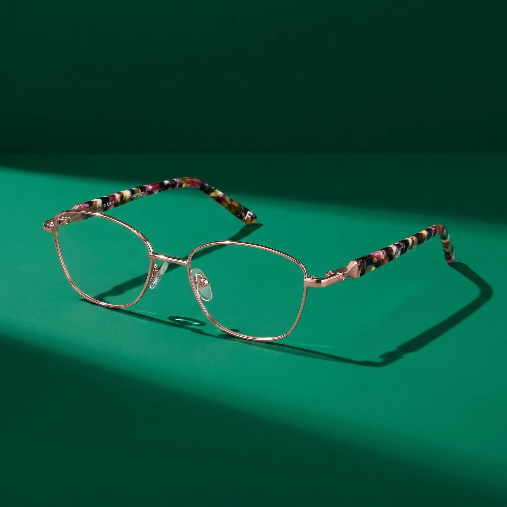 Fiore 2208 eyeglasses in brown gold – still life on a seamless emerald studio backdrop