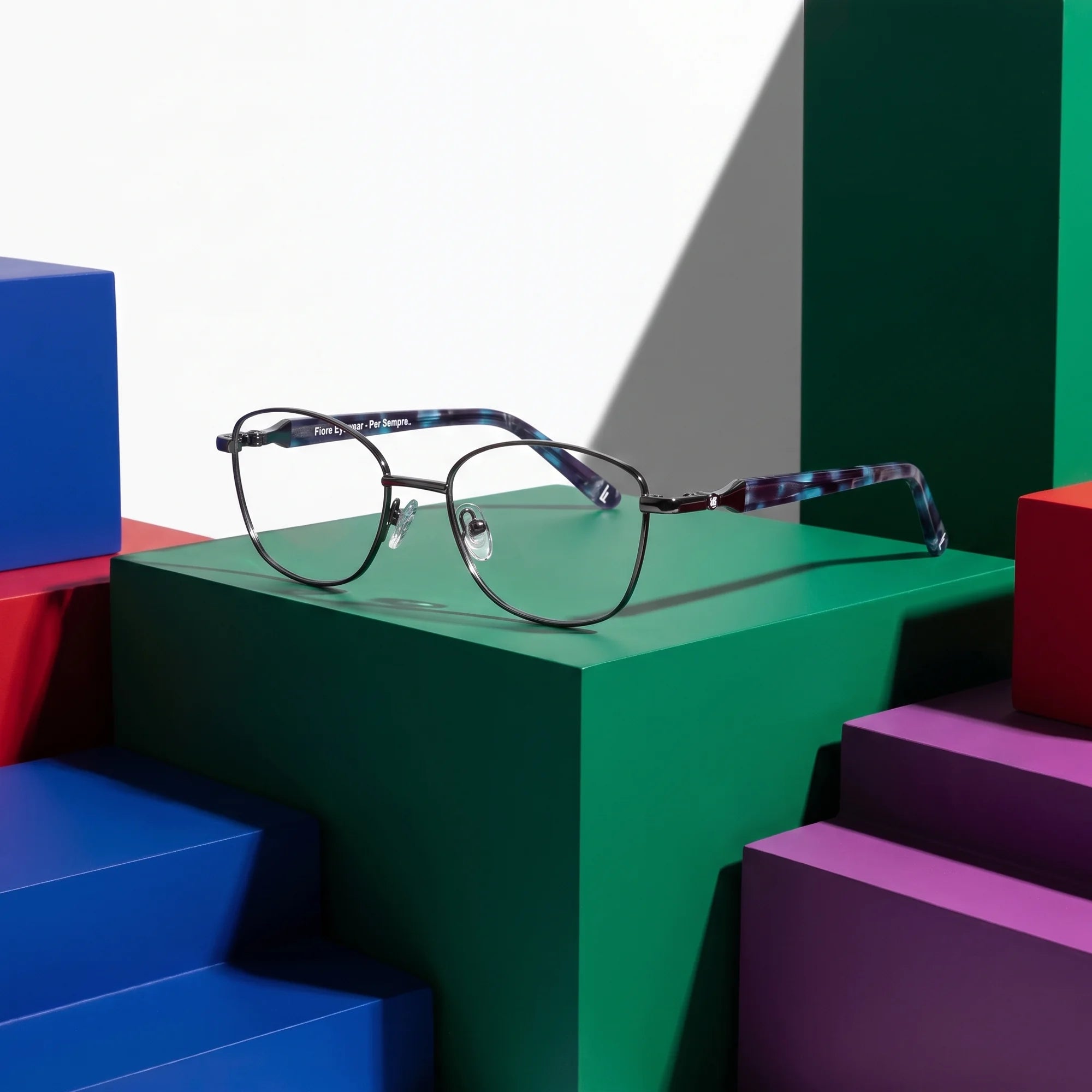 Fiore 2208 eyeglasses in gun blue – on bold primary color-block steps