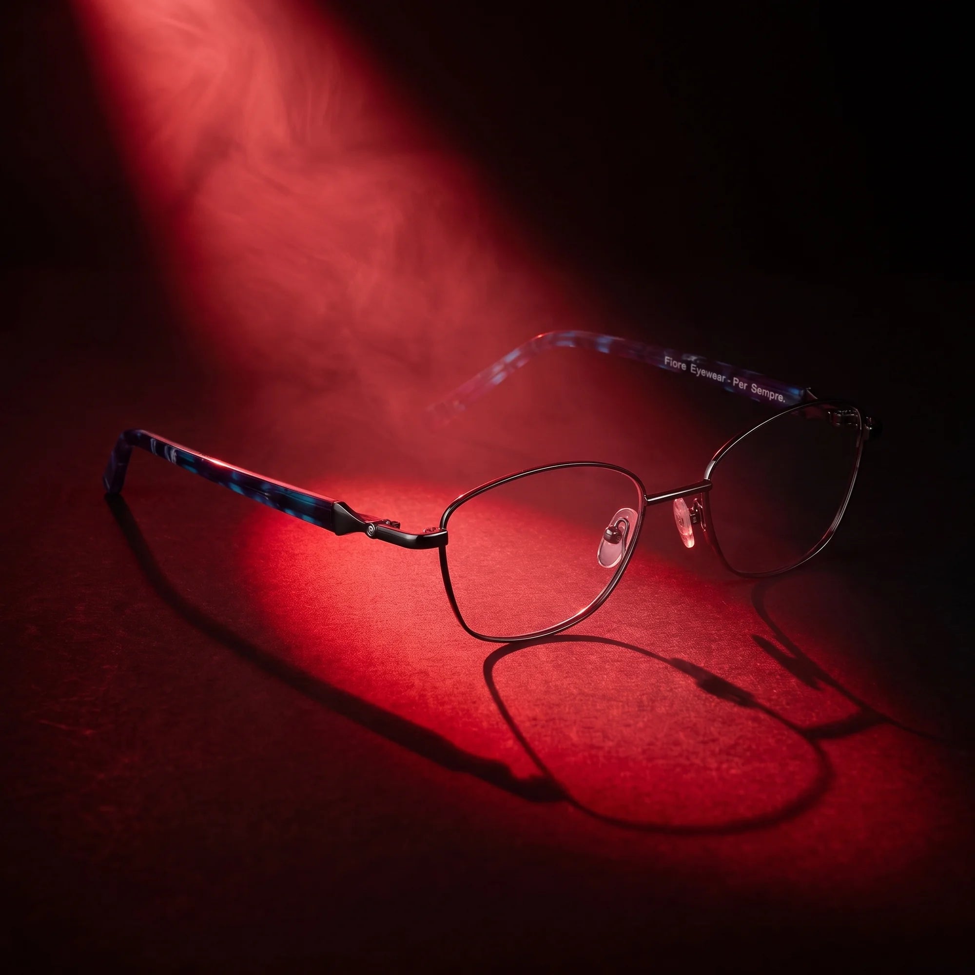 Fiore 2208 eyeglasses in gun blue – under a theatrical beam of light
