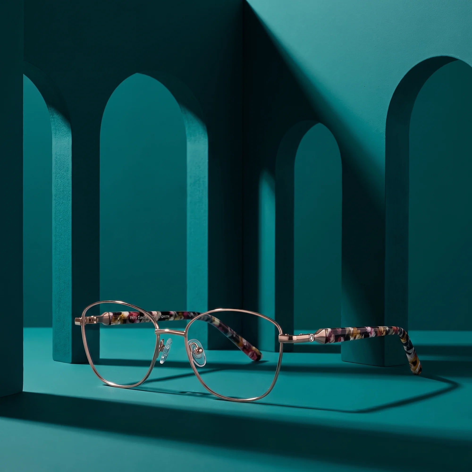Fiore 2208 eyeglasses in brown tortoiseshell – staged on a sculptural teal architecture set