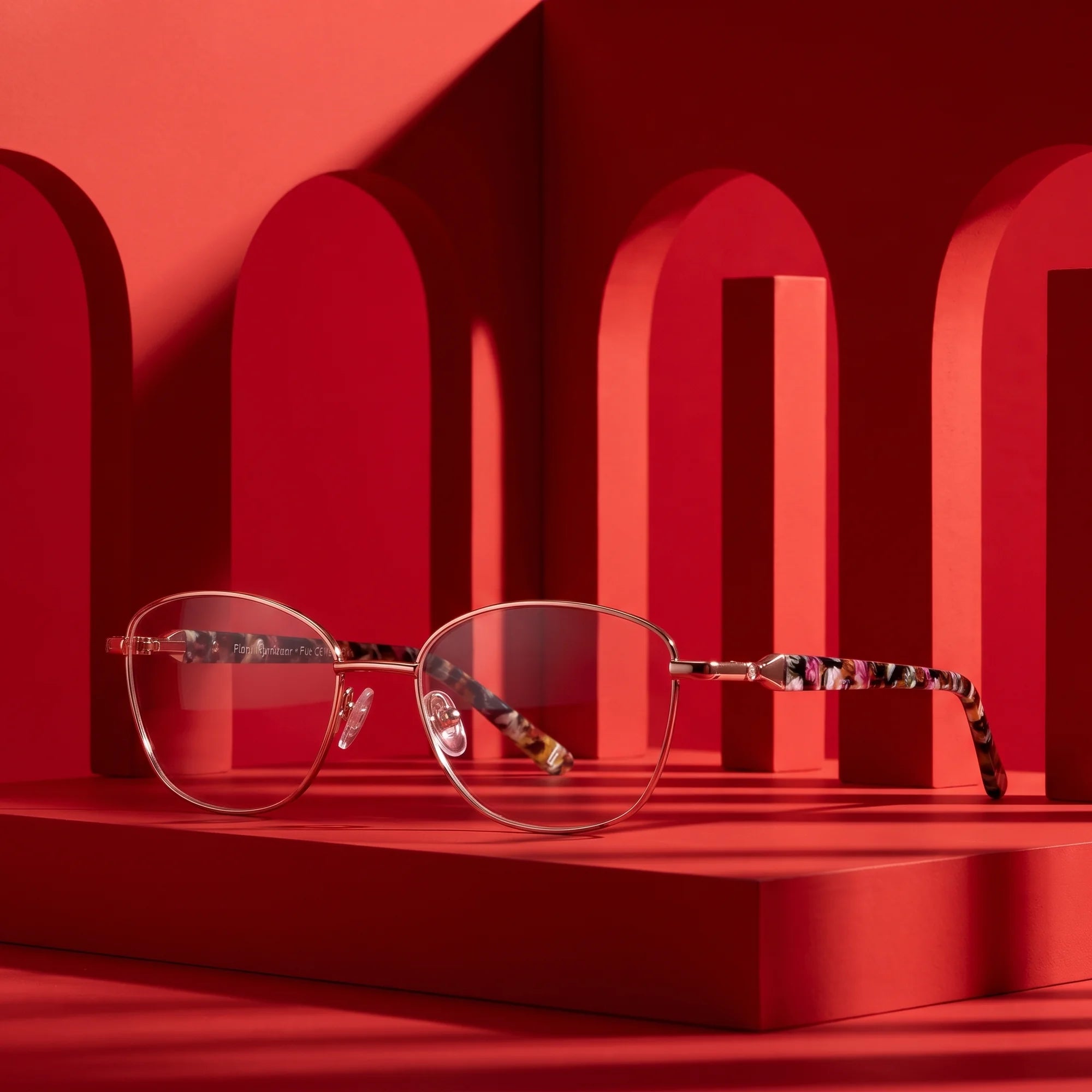 Fiore 2208 eyeglasses in brown tortoiseshell – displayed on a vivid red podium among arches