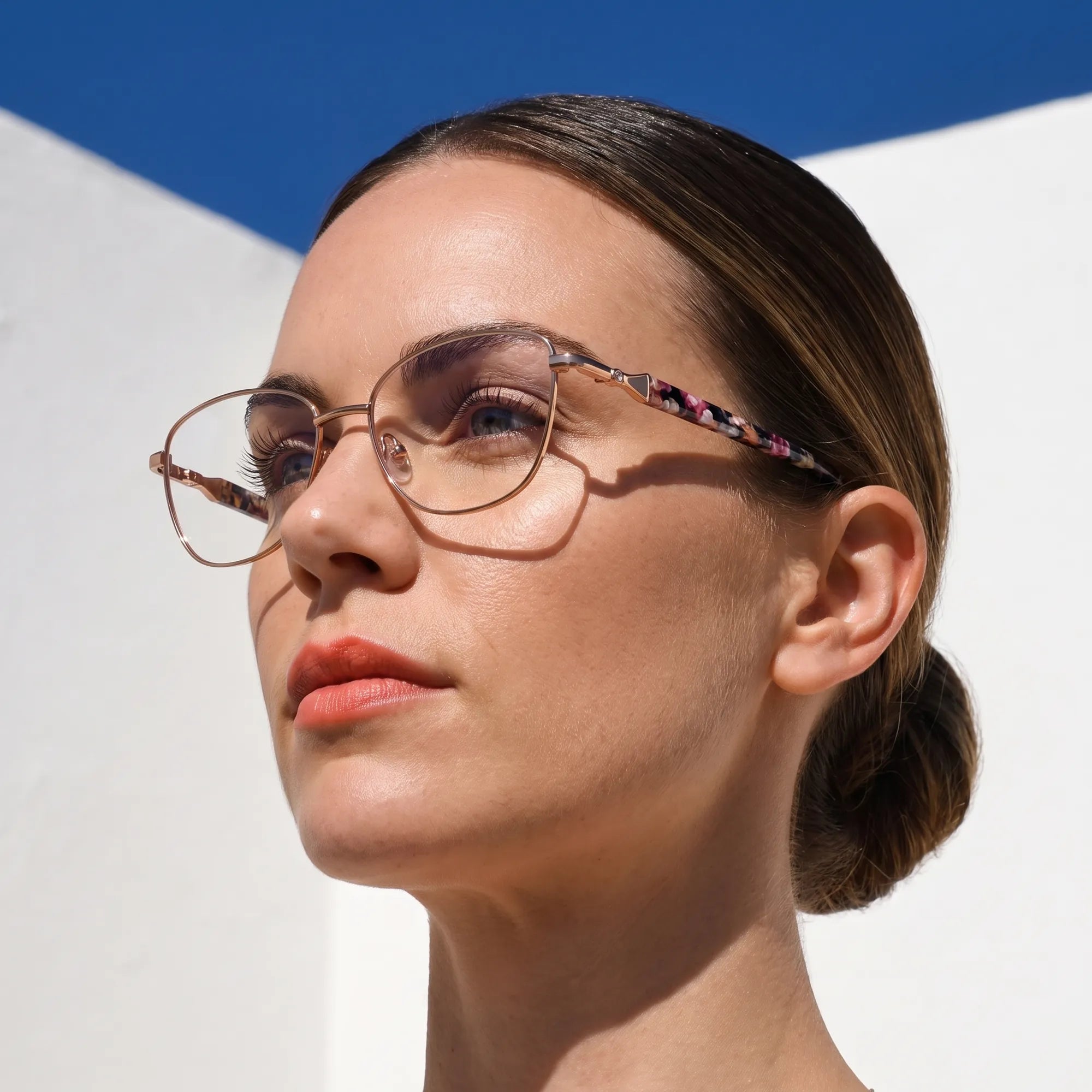 Fiore 2208 eyeglasses in brown tortoiseshell, worn by a model – campaign portrait, island rooftop portrait in summer light