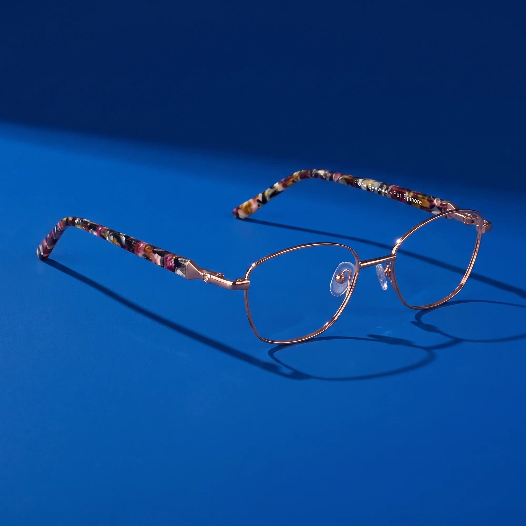 Fiore 2208 eyeglasses in brown tortoiseshell – hero still life against a deep cobalt backdrop