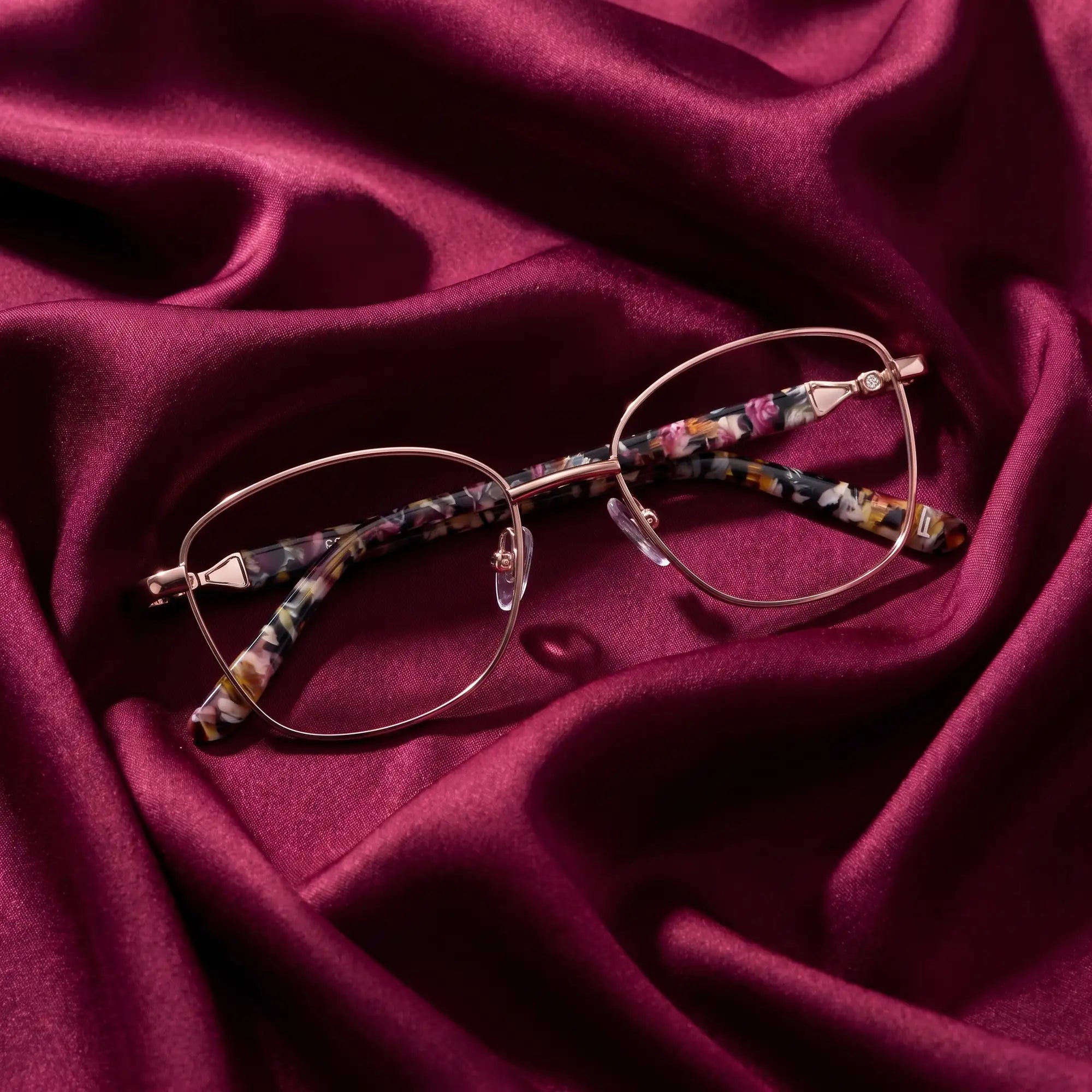 Fiore 2208 eyeglasses in brown tortoiseshell – nested in flowing burgundy silk