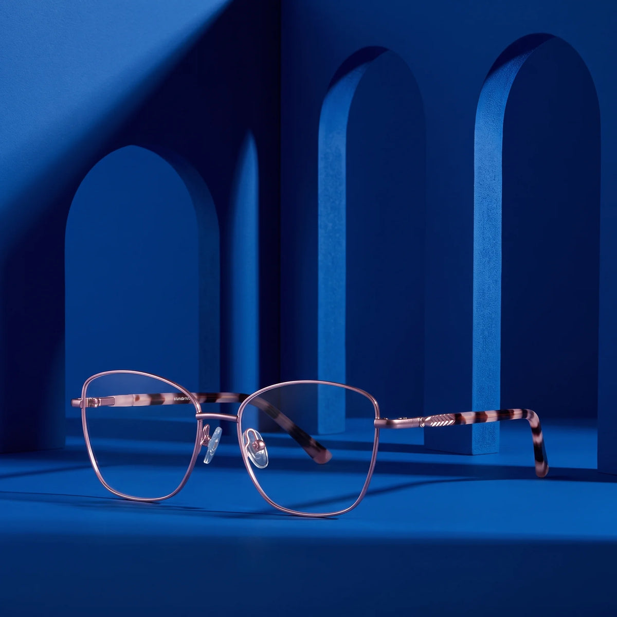 Fiore 2210 eyeglasses in pink – staged on a sculptural cobalt architecture set