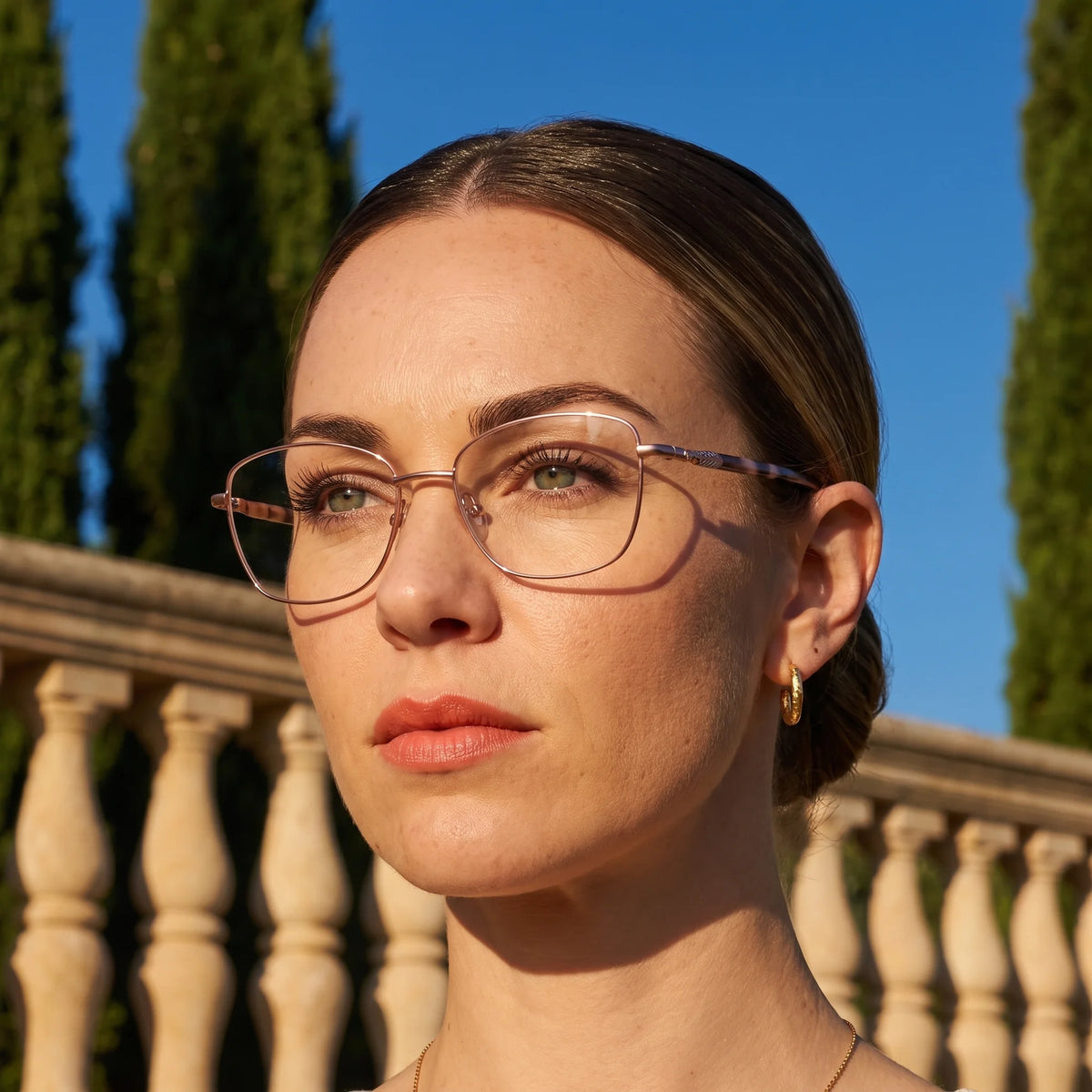 Fiore 2210 eyeglasses in pink, worn by a model – campaign portrait, golden-hour Italian villa terrace