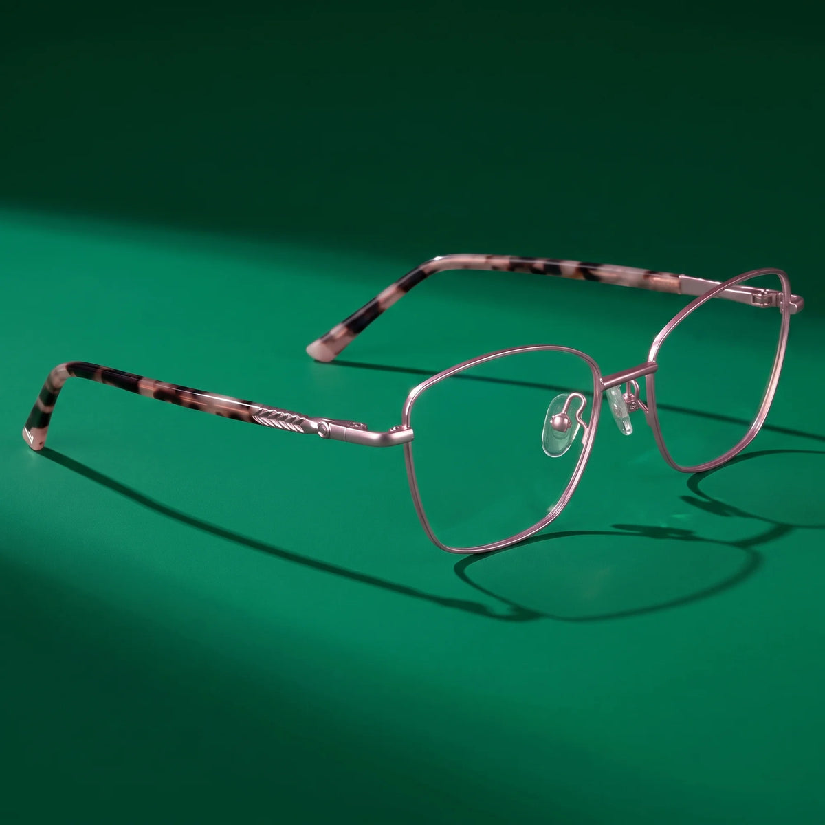 Fiore 2210 eyeglasses in pink – editorial still life on a saturated emerald set