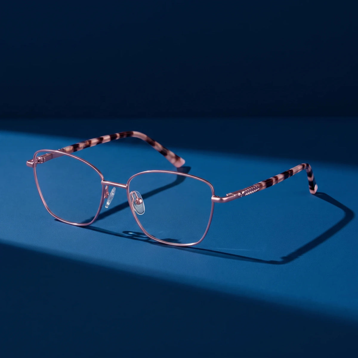 Fiore 2210 eyeglasses in pink – still life on a seamless midnight blue studio backdrop