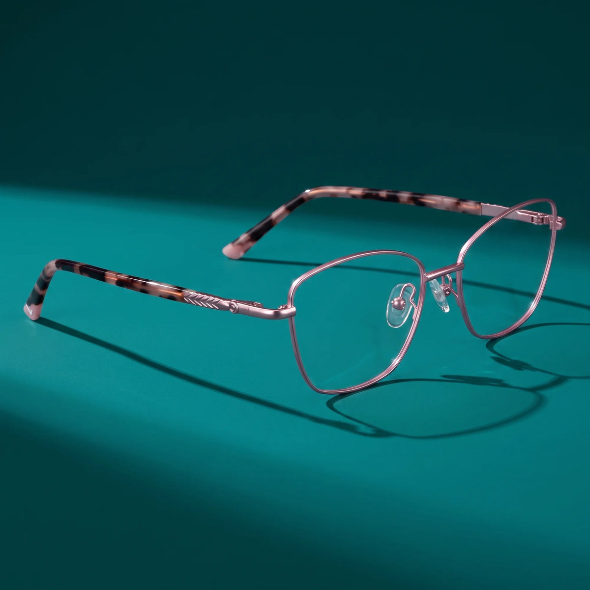 Fiore 2210 eyeglasses in pink – hero still life against a deep teal backdrop