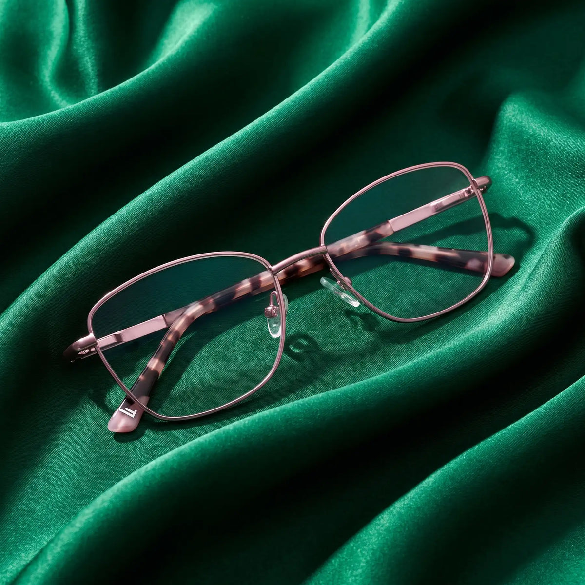 Fiore 2210 eyeglasses in pink – nested in flowing emerald silk